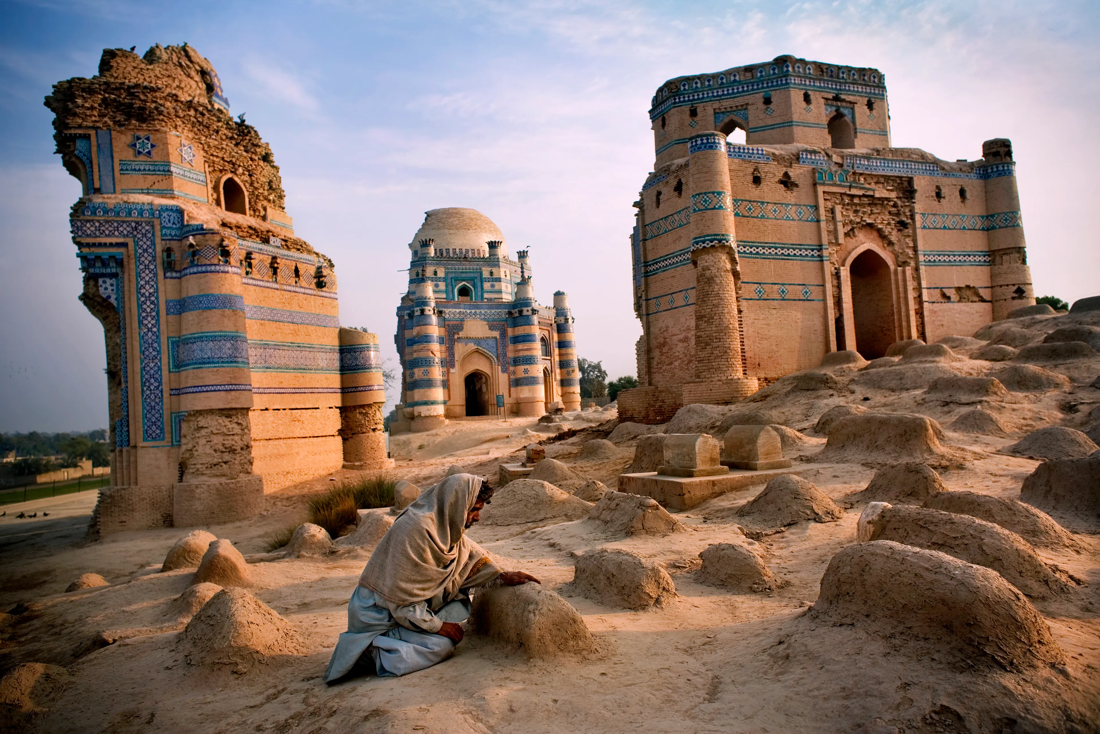 This image, of a man kneeling at a grave in Uch Sharif, Pakistan, was my first published image in National Geographic Magazine, and my favorite in a series of portraits of Sufi pilgrims I made around the world.  The Sufis are the followers of Mystic Islam.  In a time of violent extremism in the world the Sufis represented the opposite:  peace, and love, and poetry.  In Pakistan, I was told that there are three ways of knowing a thing.  The Sufis use the example of a flame.  One can be told of the flame, one can see the flame with their own eyes, and finally one can reach out and be burned by it.  In this way, Sufis seek to be burned by God.  The followers of Mystic Islam want to feel their God in the surrender of the ecstatic trance, spinning in all night ceremonies, and in poetry and mantra-like chanting.  I traveled back to Pakistan many years in a row just to hear their songs.   I hear them whenever I see an image I've taken of their world.  And I share the recordings of those songs with anyone who owns one of my images.      
Photographed in 2006,  6300 x 4201px.