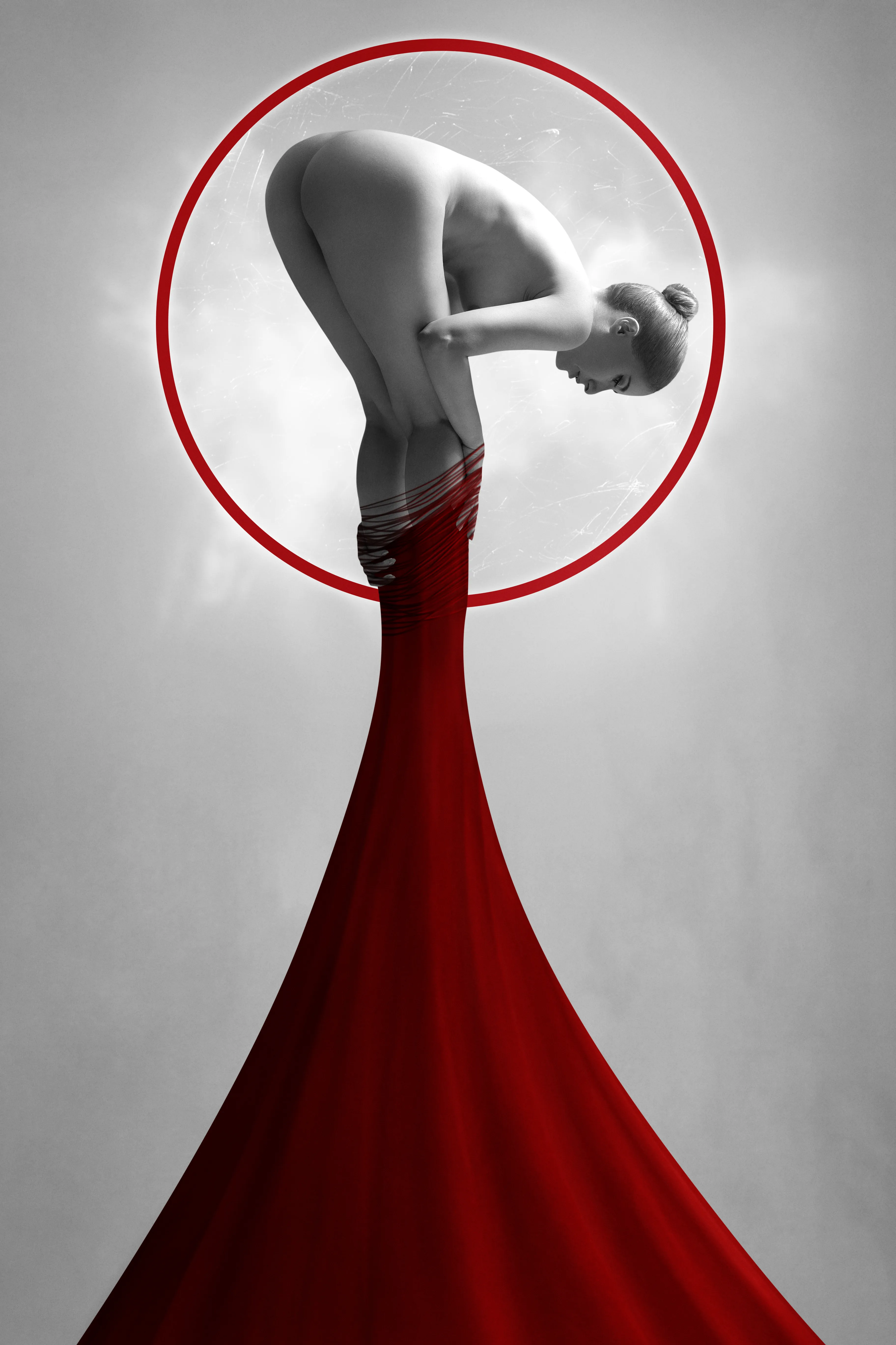 NudeArt Photography
A beautiful woman is trapped in a red circle with a red thread. A monochrome beauty colorized by red. 
She is where her desire is.