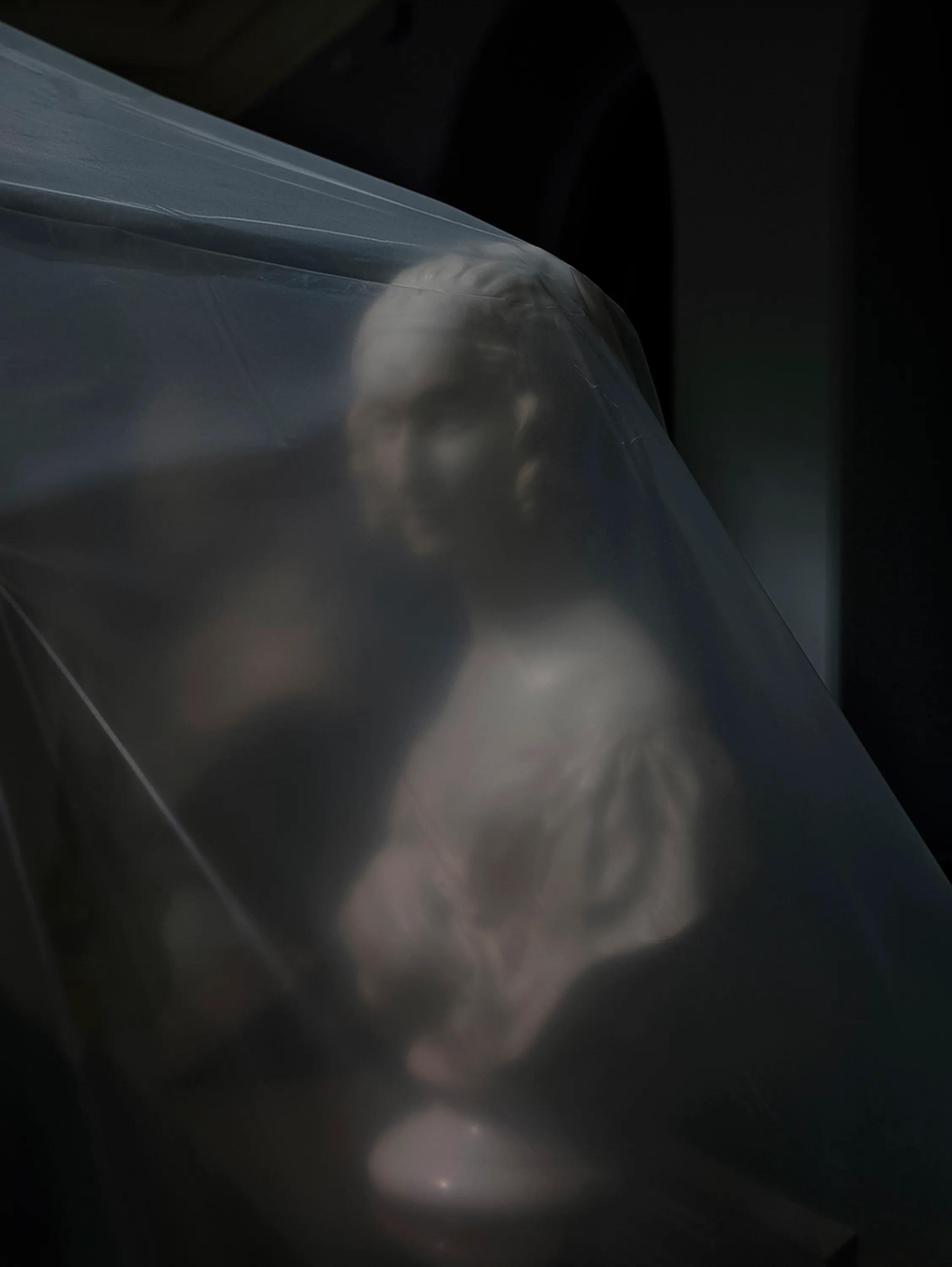 Assembly presents “Shrouded Sculptures” by UK based visual artist Simon Roberts. This NFT collection is a selection of photographs taken during the second Covid-19 lockdown whilst London’s Victoria and Albert Museum was closed to the public. These veiled statues, located in the Museum’s Dorothy and Michael Hintze Galleries, were covered for their protection during refurbishment and Roberts envisions them as a metaphor for our wider experience of the Covid-19 pandemic. The images speak of the extraordinary events of the past year, a global population suspended in time, restricted of movement and freedoms. We were forced to separate from one another, or if we were to meet, we were to hug through thick plastic sheeting, or wave through windows. The beauty of our world felt elusive, hidden beneath an entanglement of political mixed messages and misleading rhetoric. Unlike the statues of merchants, statesmen and traders, many of the sculptures in this gallery represent mythological or allegorical subjects. We see ancient mythology and 18th century neo-classicism meet 21st century plastic and gaffa tape, and the juxtaposition is eerie, disorientating and beautiful.

Simon Roberts is a visual artist based in the UK. Widely recognised for his large-format, tableaux photographs of the British landscape, his practice also encompasses video, text and installation work, which together, interrogate notions of identity and belonging, and the complex relationship between history, place and culture. His work has been exhibited nationally and internationally, and resides in major public and private collections, including the George Eastman House, Deutsche Börse Art Collection and Victoria & Albert Museum.