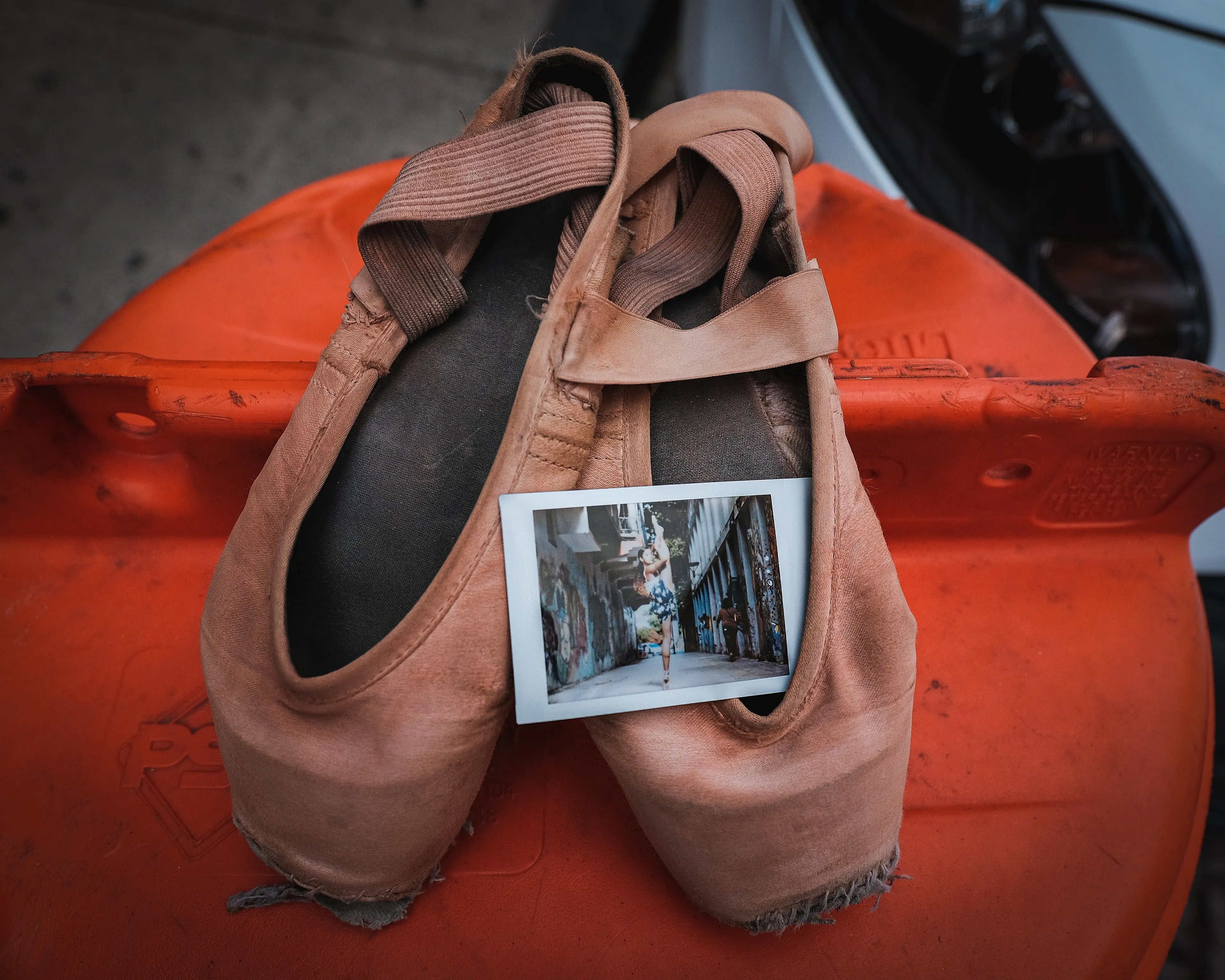 In 2013, I started a photography series that sought to inspire viewers to look at their urban surroundings in a new light. By featuring dancers in these settings, I aimed to challenge the way we perceive the spaces we encounter every day. Over the past nine years, this project has grown into a significant body of work that has shaped my career and opened up new opportunities for me. As a special gesture, I would often present the dancers with an instant photograph of our session together. Seeing their joy and pride in these mementos inspired me to start photographing them holding their instant prints. 'Dance Mementos' is a tribute to this ongoing series, showcasing a selection of my favorite images portraying the dancers with their photographs.