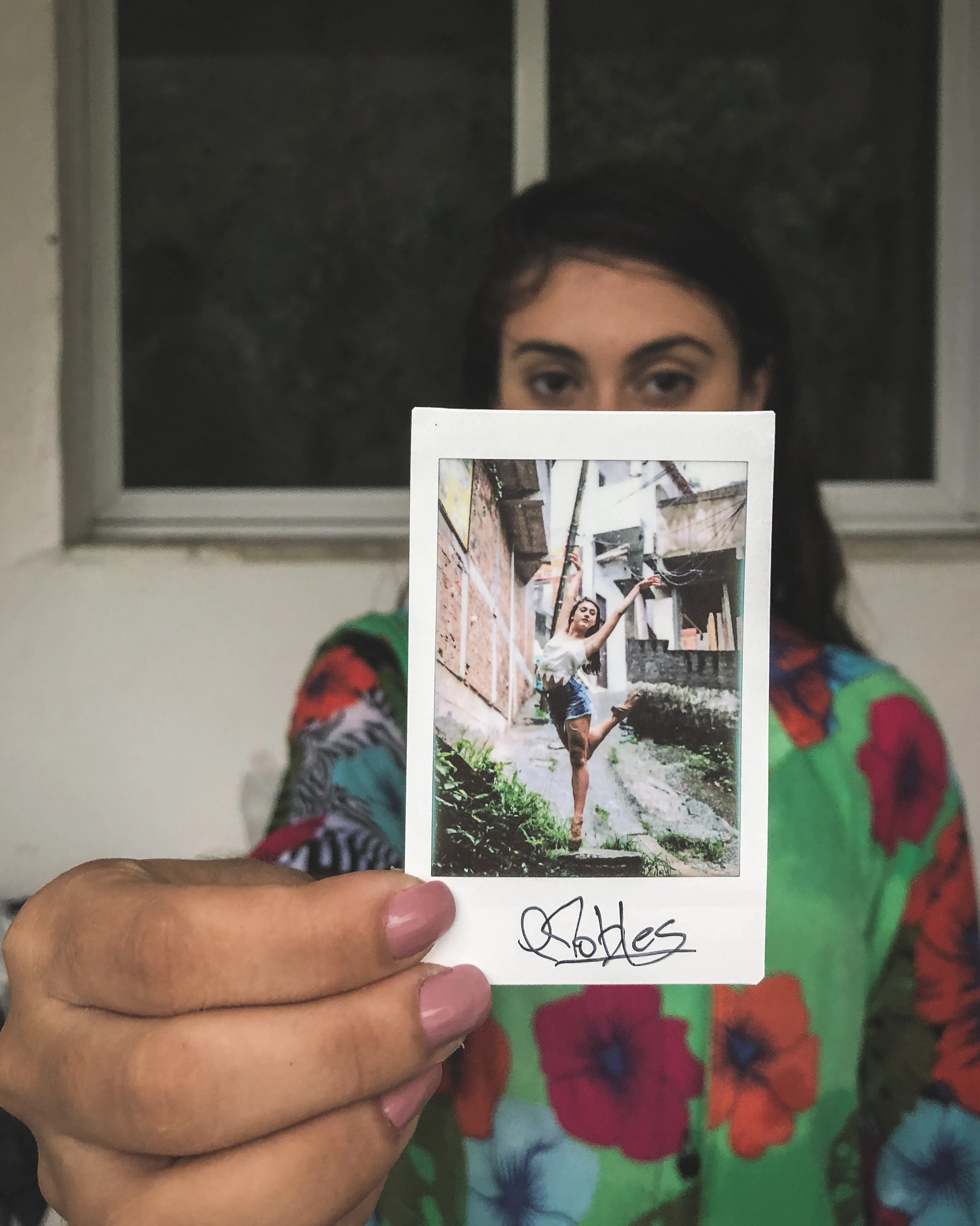 In 2013, I started a photography series that sought to inspire viewers to look at their urban surroundings in a new light. By featuring dancers in these settings, I aimed to challenge the way we perceive the spaces we encounter every day. Over the past nine years, this project has grown into a significant body of work that has shaped my career and opened up new opportunities for me. As a special gesture, I would often present the dancers with an instant photograph of our session together. Seeing their joy and pride in these mementos inspired me to start photographing them holding their instant prints. 'Dance Mementos' is a tribute to this ongoing series, showcasing a selection of my favorite images portraying the dancers with their photographs.