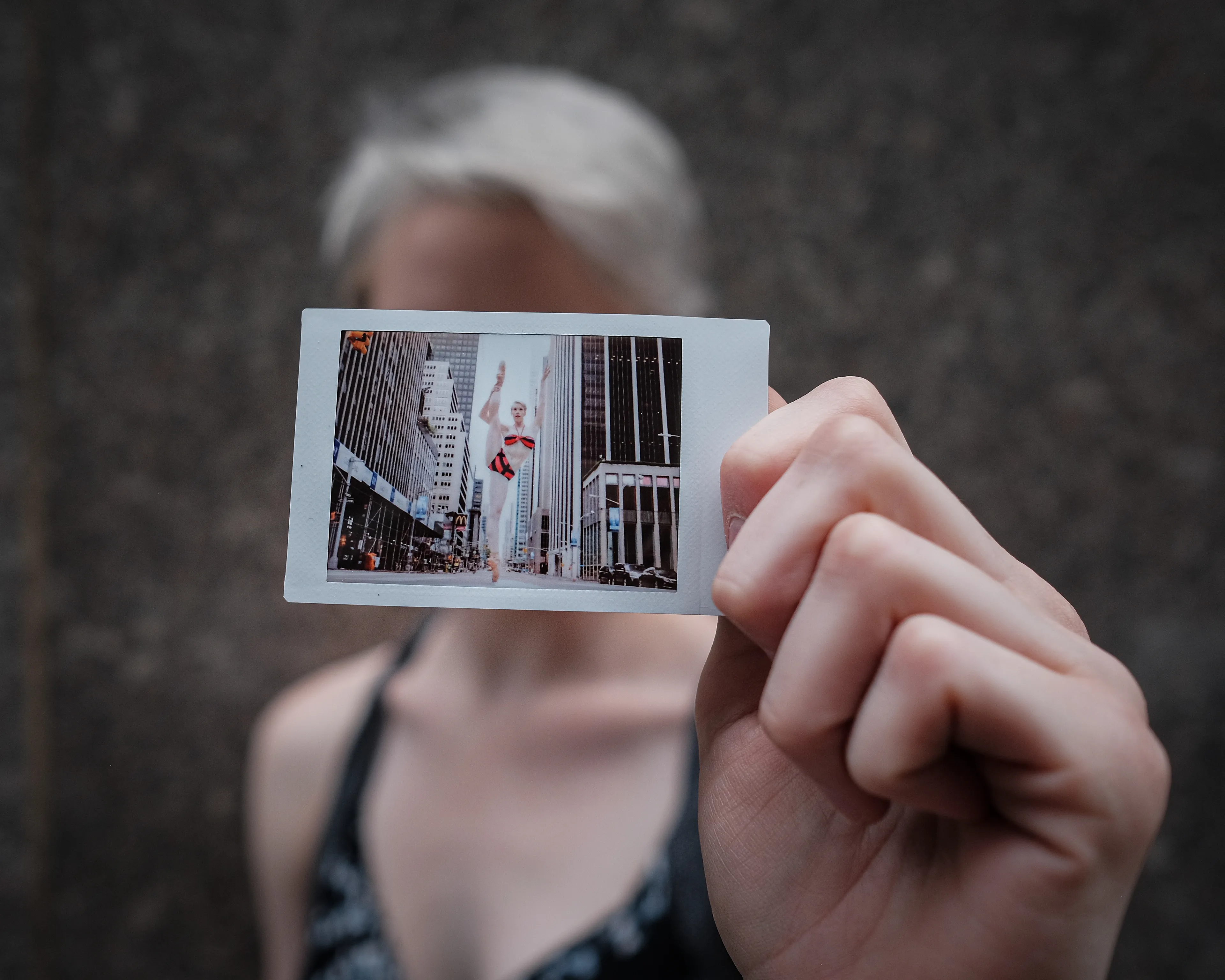 In 2013, I started a photography series that sought to inspire viewers to look at their urban surroundings in a new light. By featuring dancers in these settings, I aimed to challenge the way we perceive the spaces we encounter every day. Over the past nine years, this project has grown into a significant body of work that has shaped my career and opened up new opportunities for me. As a special gesture, I would often present the dancers with an instant photograph of our session together. Seeing their joy and pride in these mementos inspired me to start photographing them holding their instant prints. 'Dance Mementos' is a tribute to this ongoing series, showcasing a selection of my favorite images portraying the dancers with their photographs.