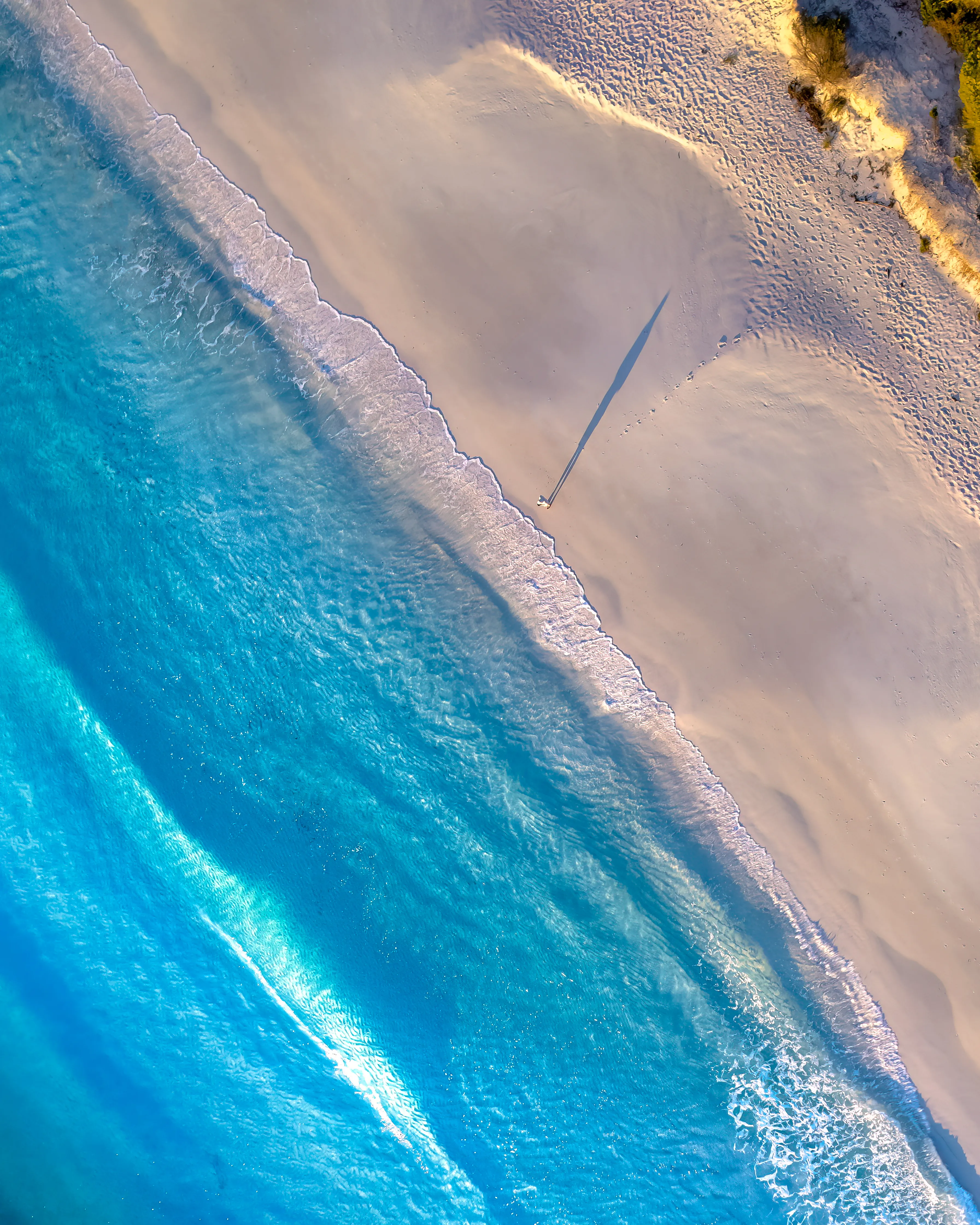 As the sun rises above the horizon, the east coast of Australia comes to life. Once voted for having the whitest sands in the world, Hyams beach is renowned for is tranquil blue waters and fine sands. A place that’s beauty is exaggerated from unique aerial perspectives.