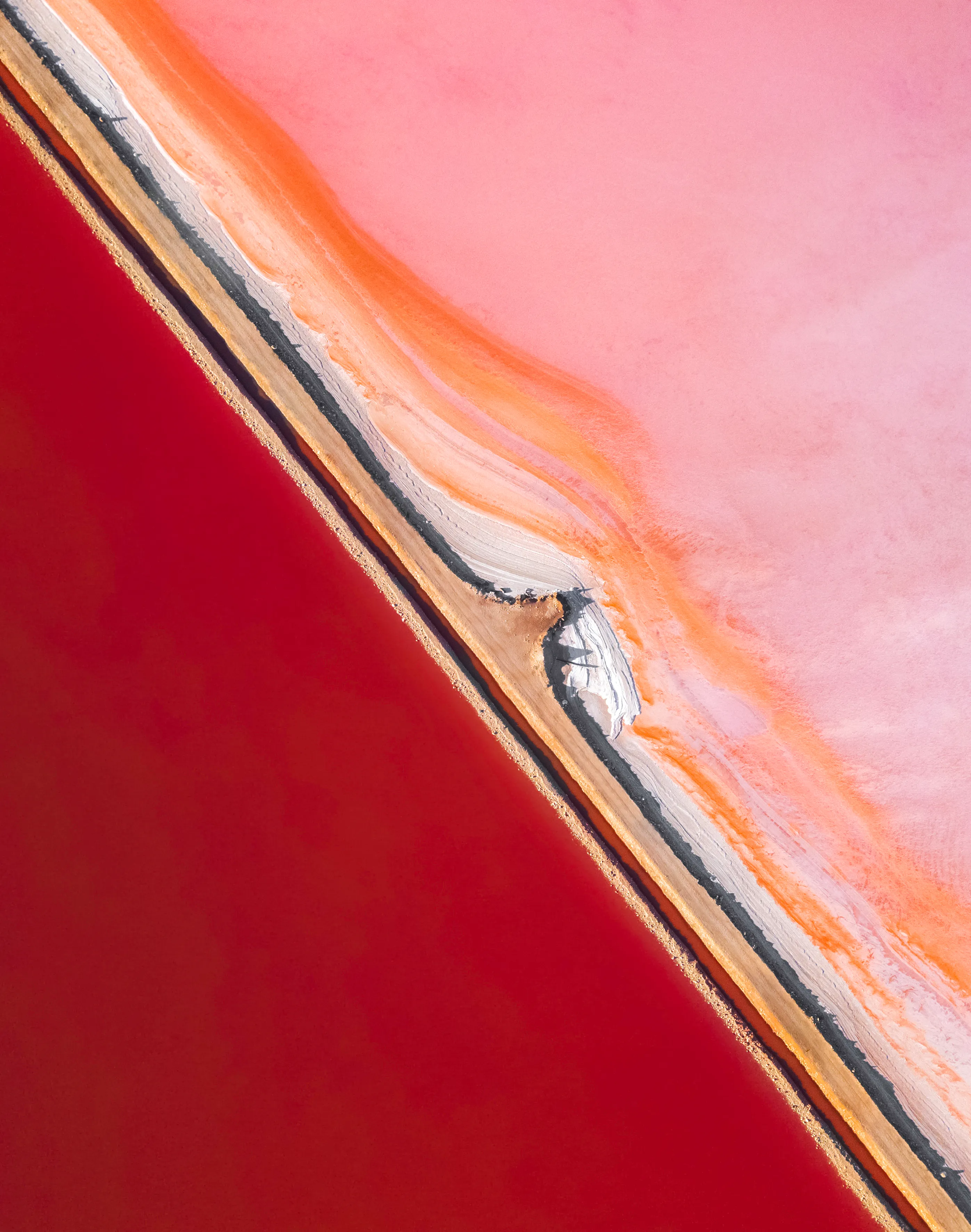 Salt farms have a unique way of looking so magical from the air. Their vibrant colours are so special and a reason why I love capturing their beauty. This image was taken in Western Australia with a drone and is completely real. The salt water gets its pink colour due to the presence of algae dunaliella salina. This algae is actually a food colouring agent and used in cosmetics and dietary supplements.