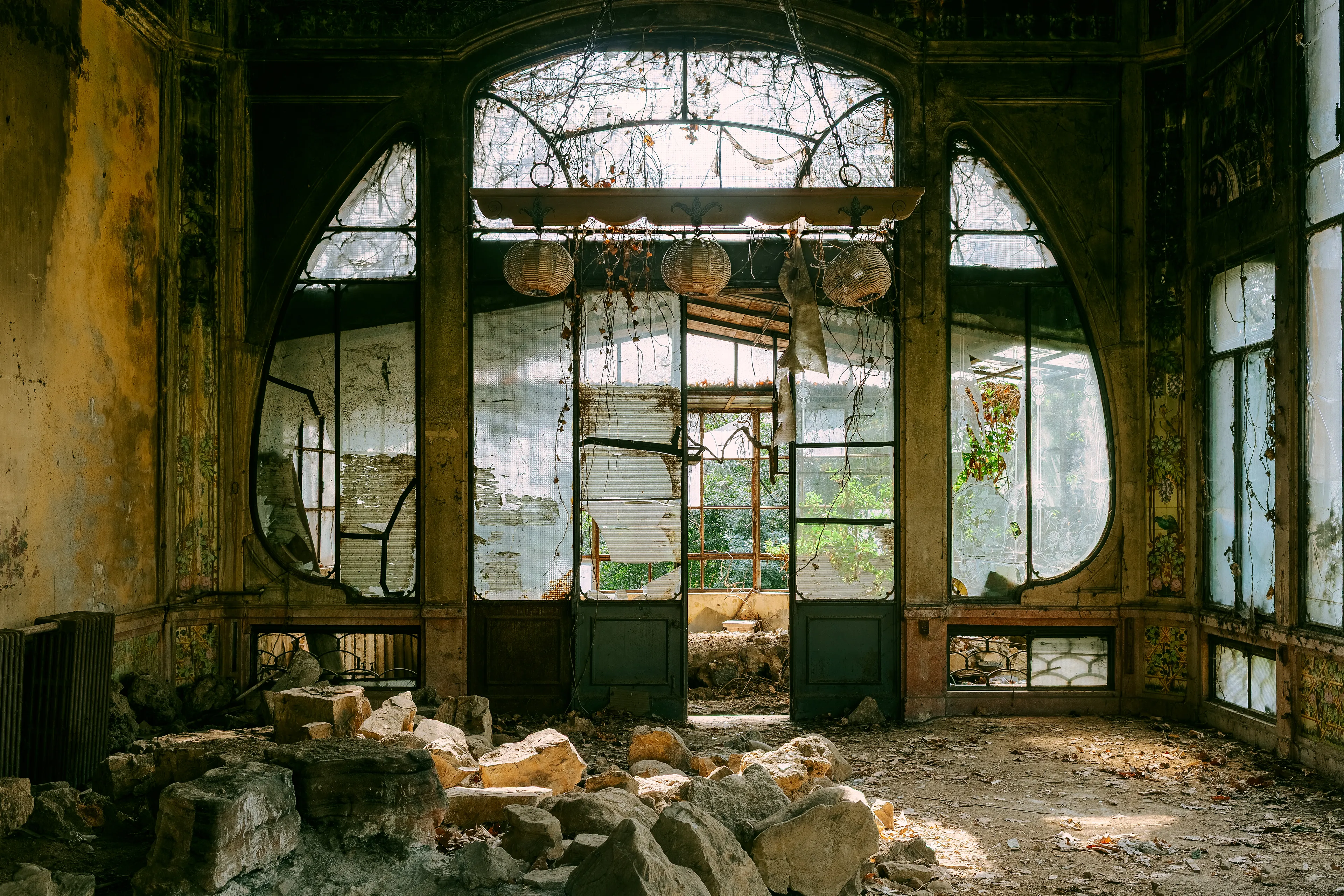 The Garden

Everything is broken —
but the green keeps coming back.
Vines, dust, shattered glass.
What once was shelter
is now a threshold.