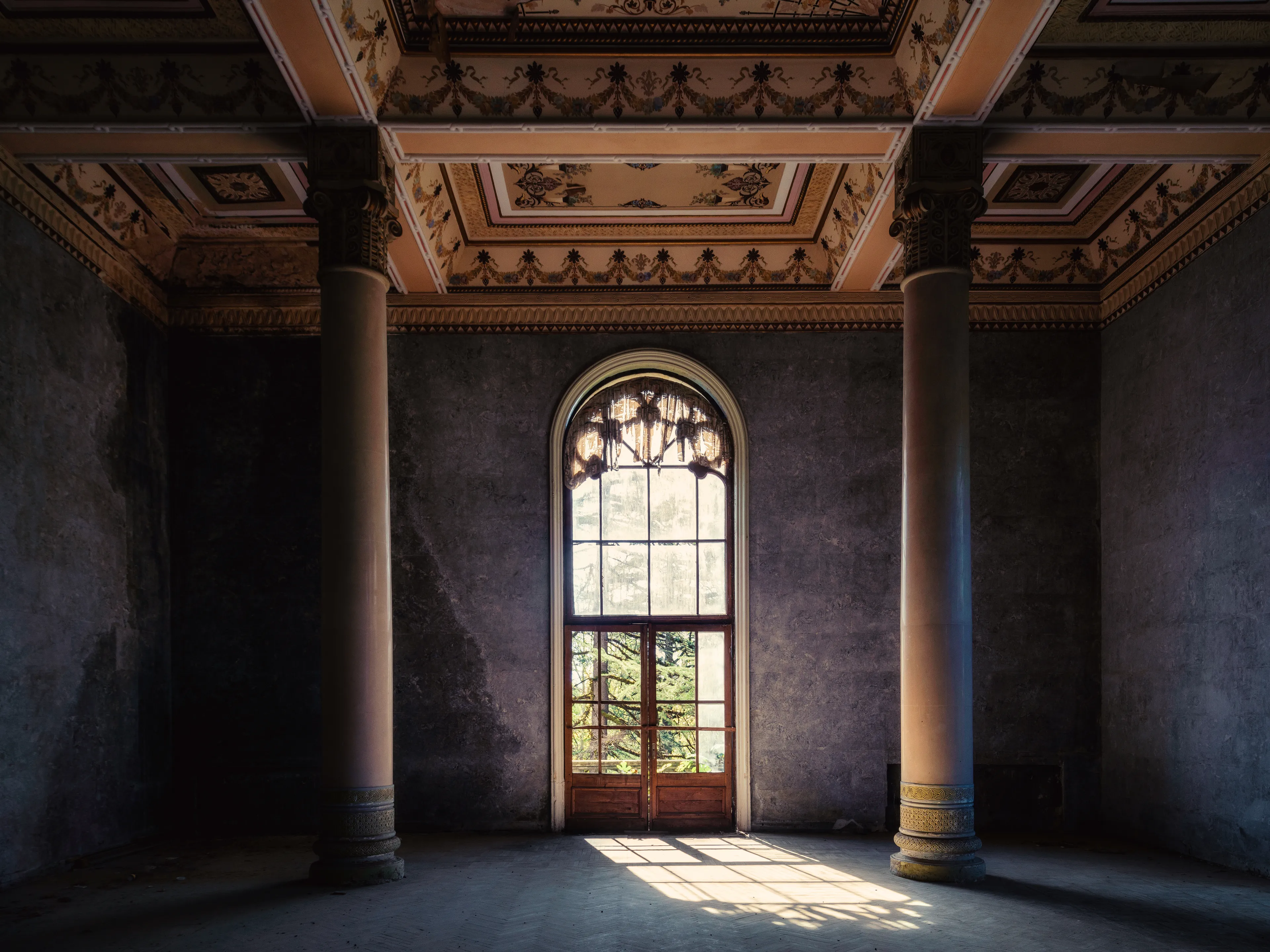 No voices.
No movement.
Only two columns, a faded curtain,
and the afternoon sun rehearsing memory.
Light doesn’t need words —
it simply remains.