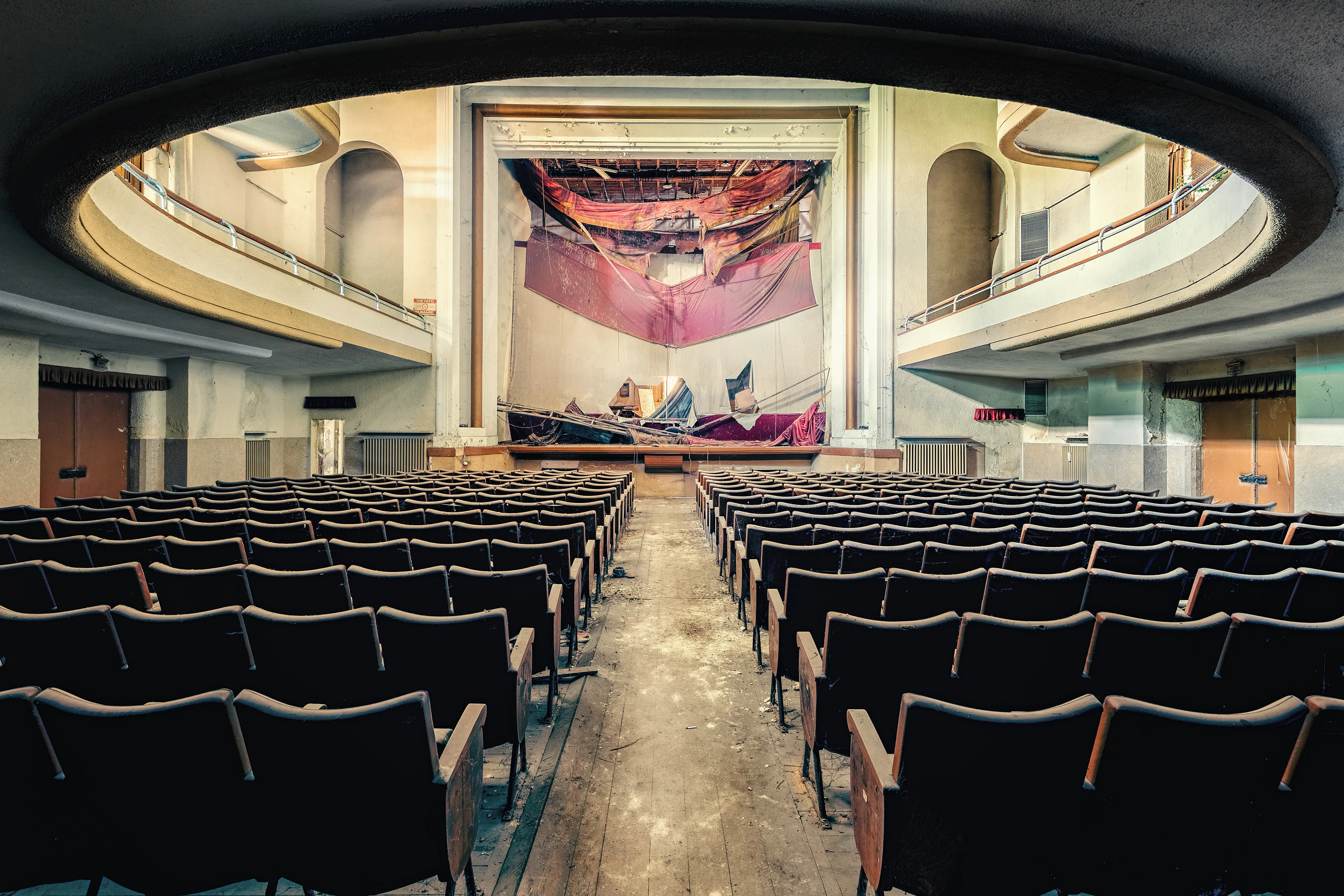 The curtain never closed.
It simply gave up.
Rows of empty chairs,
a stage with no exit —
and silence performing its longest role yet.