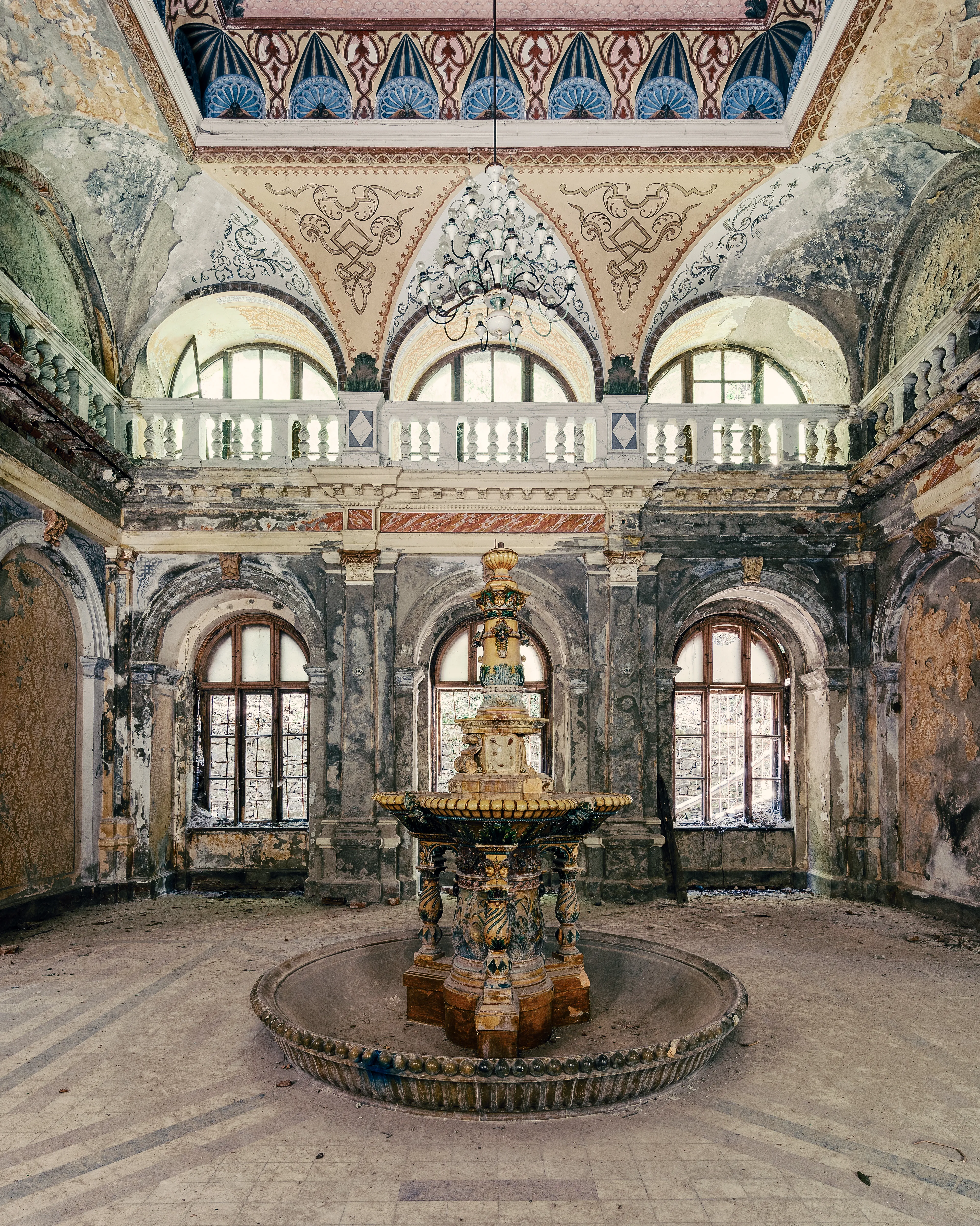 The Neptune Baths in Baile Herculane (Romania).
This old spa was built in the Viennese Baroque style. No wonder that the Austrian Emperor and Empress Franz Josef I and Sissi were often guests here to relax.

Unfortunately, these glorious times are long gone. Classical music no longer sounds through the long corridors, but the wind whistles its melody there.

It is almost like a miracle that the beautiful fountain in the main hall is still so wonderfully preserved.

