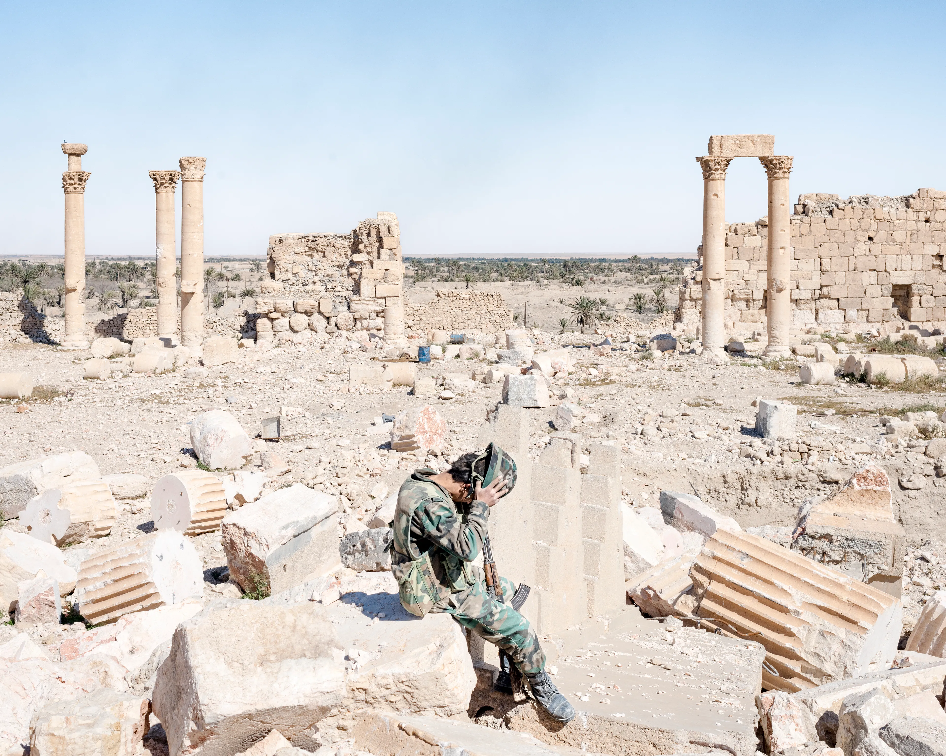 Magnum 75 #104 by Lorenzo Meloni. Palmyra, Syria. 2016  
A Syrian Army soldier removes his helmet, sitting on the rubble of the former Temple of Bel, one of several sites in Ancient Palmyra destroyed by Islamic State militants.

Magnum 75 is the inaugural NFT collection by Magnum Photos. Created in 2022 for the agency’s 75th anniversary year and released in three curations, the collection brings together 225 iconic images from Magnum photographers, taken across seven decades.

Each curation is composed in dialogue with a leading picture editor from across the globe and selected to embody the agency’s past, present, and future. This second curation was made in dialogue with Azu Nwagbogu, founder and director of African Artists’ Foundation and director of LagosPhoto Festival.

Nwagbogu says: “The vast Magnum archive reveals so much about the history of the modern world and its unresolved global issues with regard to ecology, humanity and technology. Rather than exploring Henri Cartier-Bresson’s ‘decisive moment,’ this collection studies the ‘indecisive moment’ — the interstitial spaces, the energized subjects floating in-between events, where little obvious action occurs but where the subject(s) seem to be caught in anticipation. Each image is charged with feeling, intent, foreboding, and meaning, composed with a sense of expectation that offers multiple scenarios and possibilities about past events. It is not revisionist history, but rather invites the collector and viewers to perhaps look at the image again, more closely.”

Edition: 1 of 1

© Lorenzo Meloni/Magnum Photos 2022 All Rights Reserved  
www.magnumphotos.com/terms-conditions/