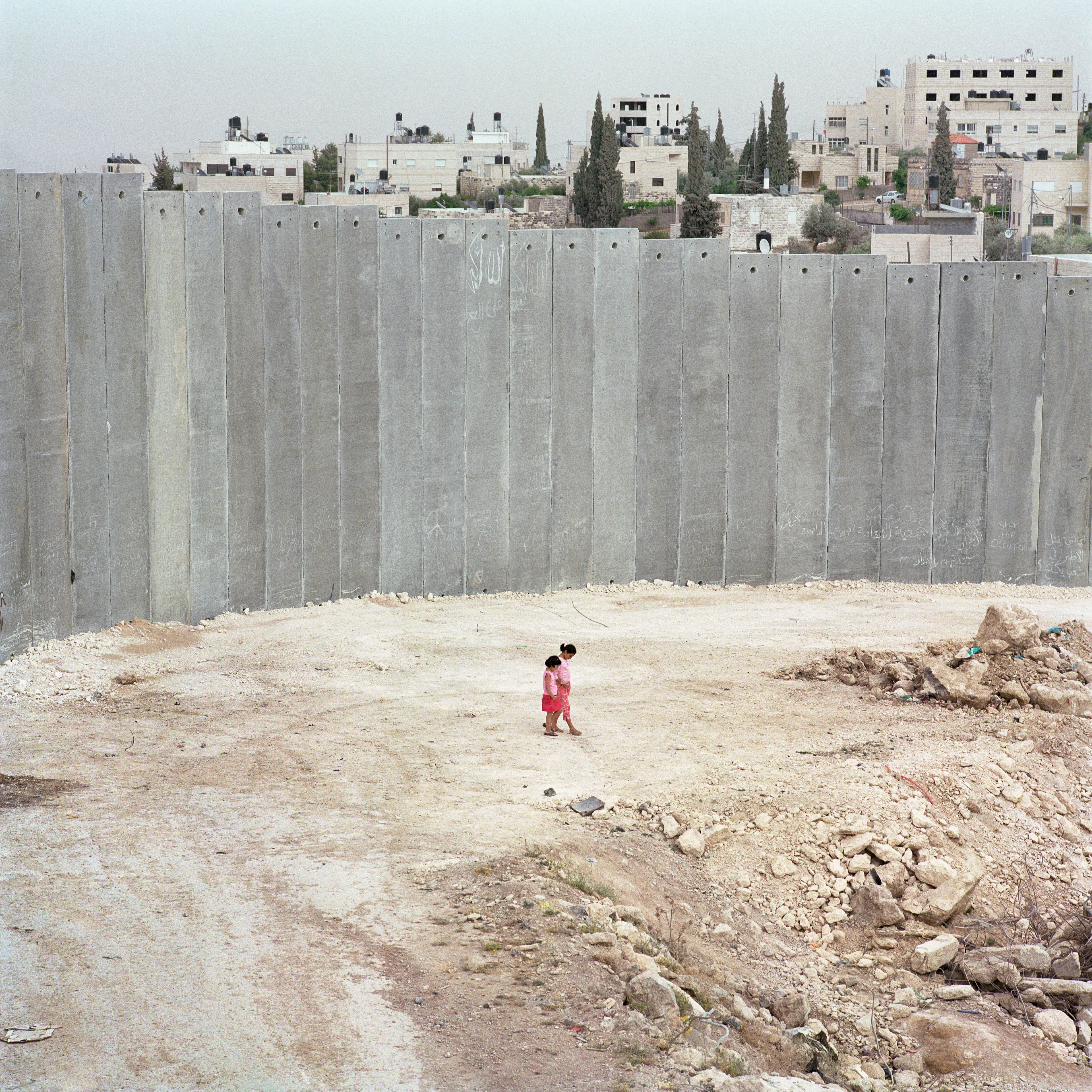Magnum 75 #27 by Alessandra Sanguinetti. Abu Dis, West Bank. 2004  
The separation wall. 

The Magnum 75 collection is the inaugural NFT collection by Magnum Photos. Created in 2022, the collection brings together works by 76 photographers taken across seven decades. 

Each drop will be curated in dialogue with three leading picture editors from across the globe and selected to embody the agency’s past, present, and future. This collection release coincides with the agency’s 75th celebrations and its Annual General Meeting in New York. 

The first collection has been curated by Alejandro Cartagena, co-founder of Obscura.

Alejandro Cartagena said: "To look into Magnum’s vast archive is to look into the evolving history of photography as a language. For this selection, which marks the first steps of the agency into yet another horizon for photography with the emergence of blockchain technology, I decided to focus on the ingredients that make certain images stand out from the rest – the elements that all photographers should be aiming for. These 76 images celebrate not only the endurance of Magnum Photos but the quality that has made this longevity possible."

Edition: 1 of 1

© Alessandra Sanguinetti/Magnum Photos 2022 All Rights Reserved  
www.magnumphotos.com/terms-conditions/