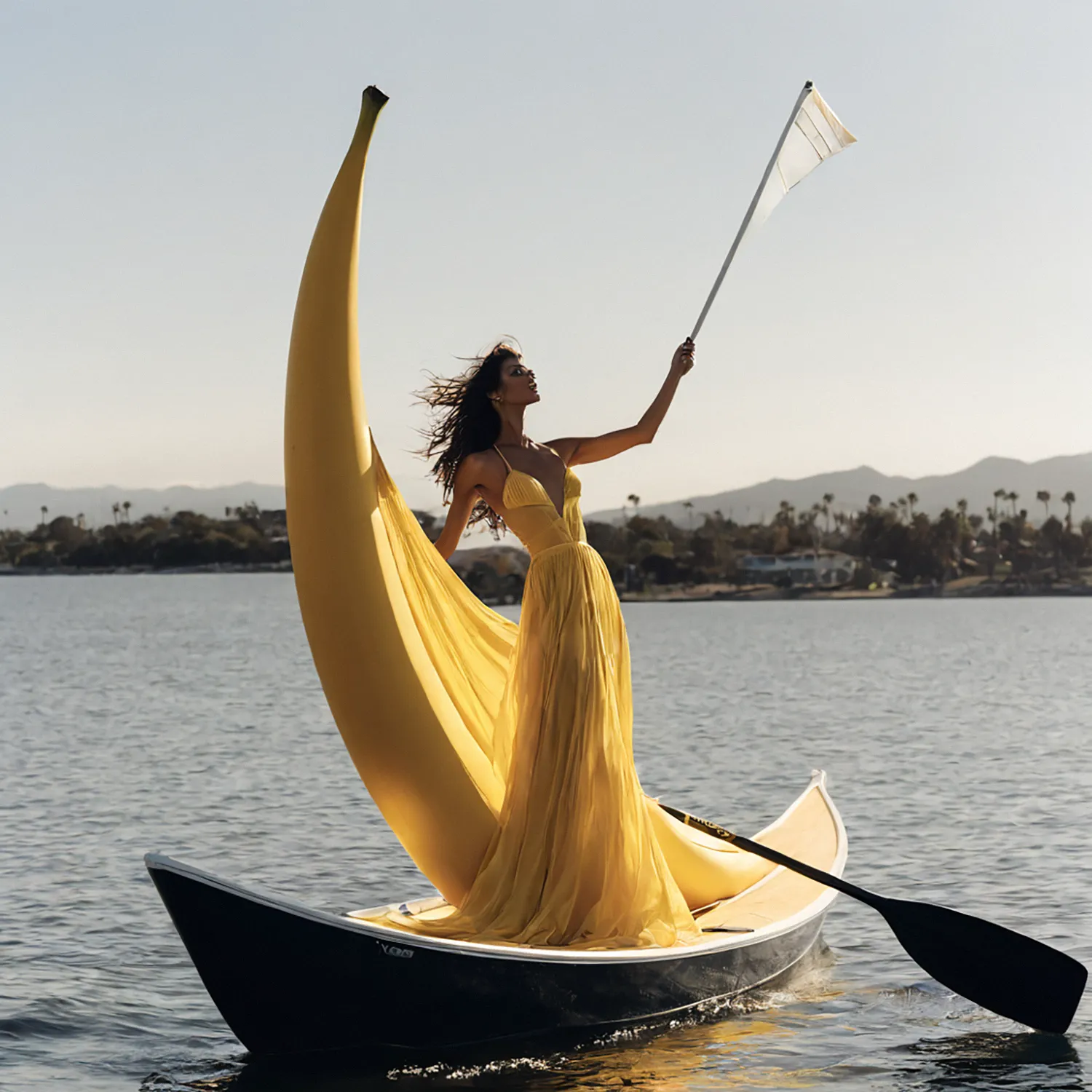On the tranquil waters of San Jose, a woman stands atop a boat, her attire a vibrant tribute to the tropical allure of the surroundings. Adorned in an outfit inspired by bananas, she exudes an aura of whimsy and charm as the warm sunlight dances upon the rippling waves. Against the backdrop of the azure sky and the gentle swaying of palm trees, she embodies the carefree spirit of a sun-kissed paradise, her presence adding a touch of vibrant energy to the serene waters of San Jose.
