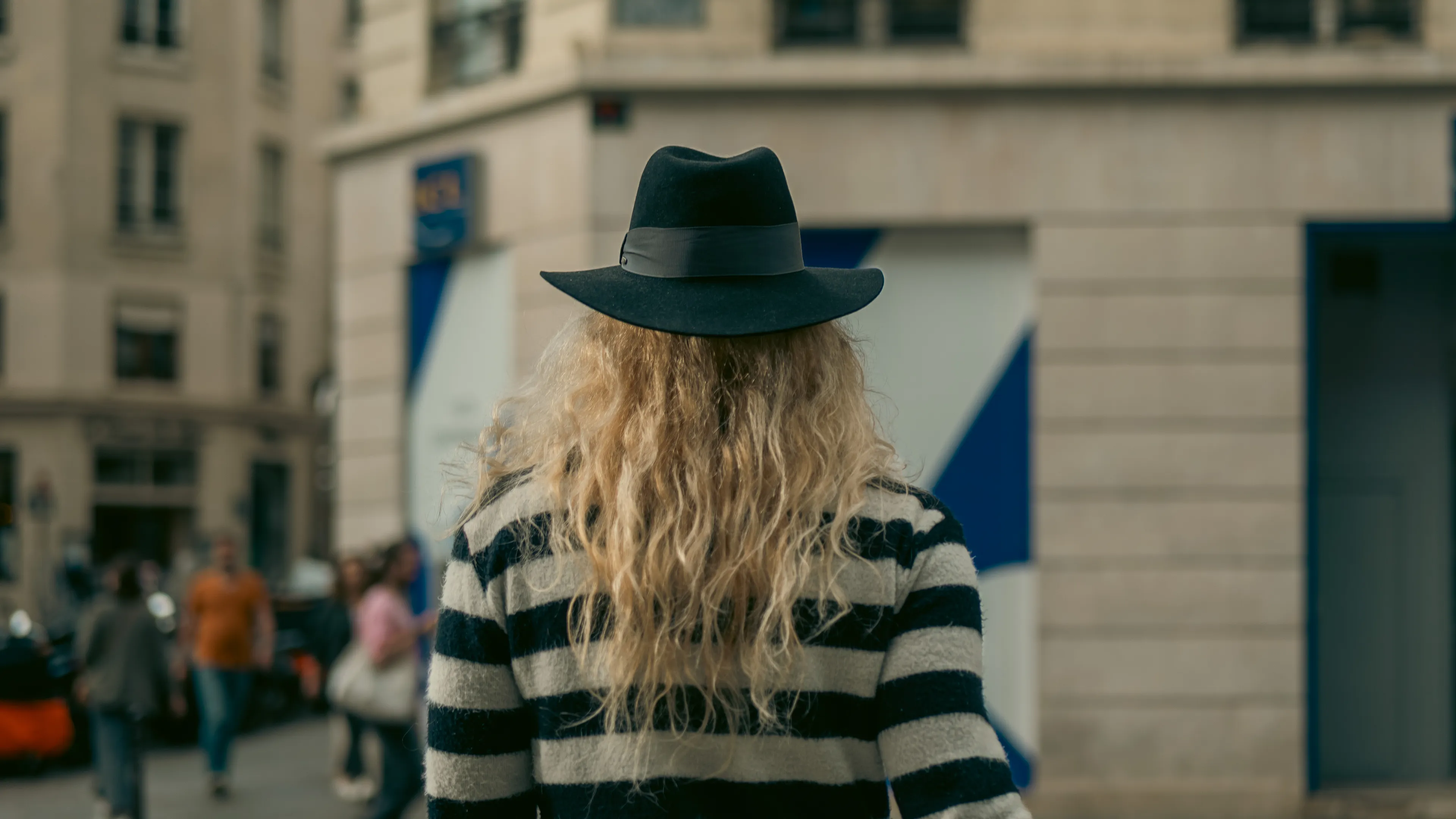 City Hats explores individuality through cinematic street portraits, inspired by my earlier series, City. Framed in 16:9, these photographs center on the backs of strangers wearing hats—highlighting style while leaving identity unseen. Each hat tells a story, echoing Lily Dache's words: "The hat is the expression of who we are, where we're going, and where we've been."

These aren't portraits of fashion, but of gesture, posture, and presence. A hat becomes a shorthand for personality—a quiet declaration of character, intention, or mood. Seen from behind, each figure feels like someone entering a movie scene mid-story—anonymous, yet already alive with narrative.

As the film Arizona Dream reminds us: "Even without pants… you didn't have to be ashamed of your ass as long as you had a hat."