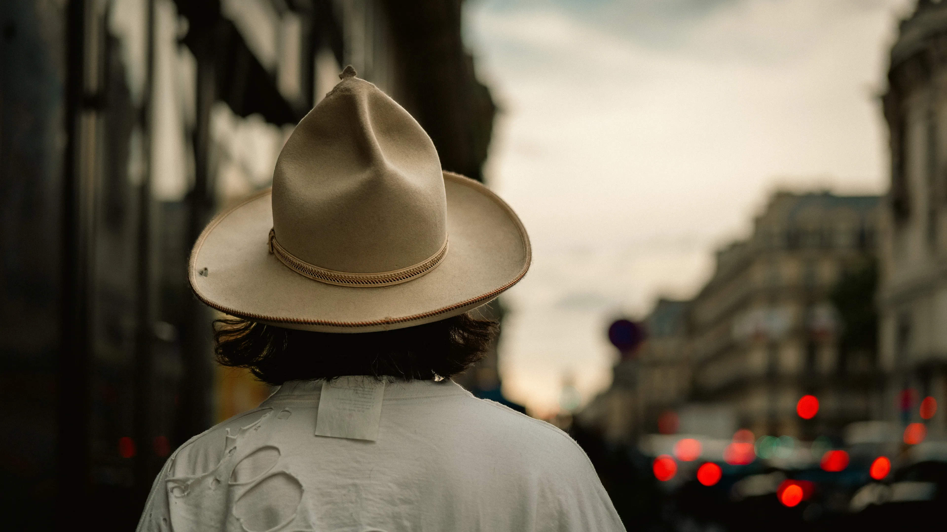 City Hats explores individuality through cinematic street portraits, inspired by my earlier series, City. Framed in 16:9, these photographs center on the backs of strangers wearing hats—highlighting style while leaving identity unseen. Each hat tells a story, echoing Lily Dache's words: "The hat is the expression of who we are, where we're going, and where we've been."

These aren't portraits of fashion, but of gesture, posture, and presence. A hat becomes a shorthand for personality—a quiet declaration of character, intention, or mood. Seen from behind, each figure feels like someone entering a movie scene mid-story—anonymous, yet already alive with narrative.

As the film Arizona Dream reminds us: "Even without pants… you didn't have to be ashamed of your ass as long as you had a hat."