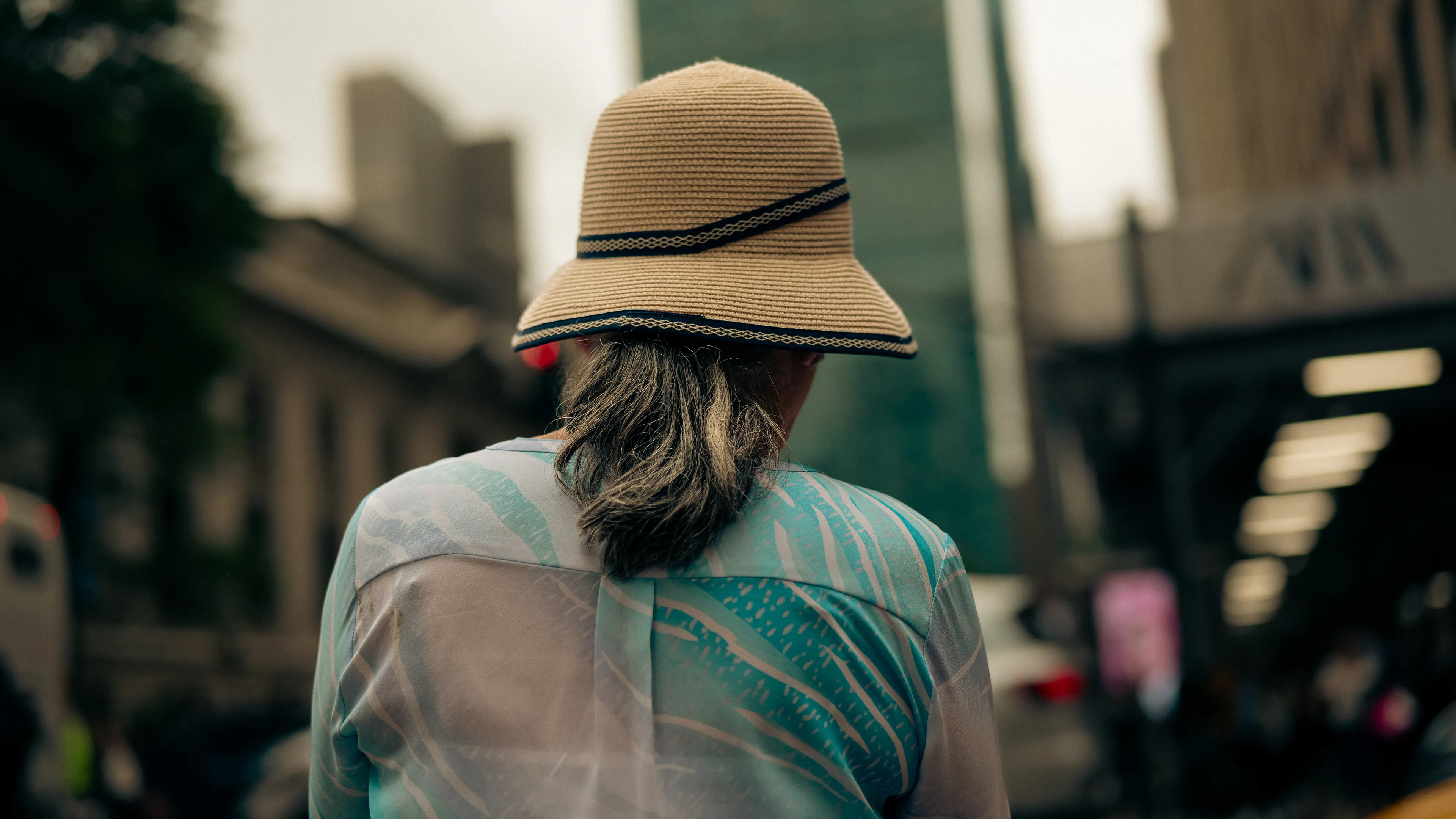 City Hats explores individuality through cinematic street portraits, inspired by my earlier series, City. Framed in 16:9, these photographs center on the backs of strangers wearing hats—highlighting style while leaving identity unseen. Each hat tells a story, echoing Lily Dache's words: "The hat is the expression of who we are, where we're going, and where we've been."

These aren't portraits of fashion, but of gesture, posture, and presence. A hat becomes a shorthand for personality—a quiet declaration of character, intention, or mood. Seen from behind, each figure feels like someone entering a movie scene mid-story—anonymous, yet already alive with narrative.

As the film Arizona Dream reminds us: "Even without pants… you didn't have to be ashamed of your ass as long as you had a hat."