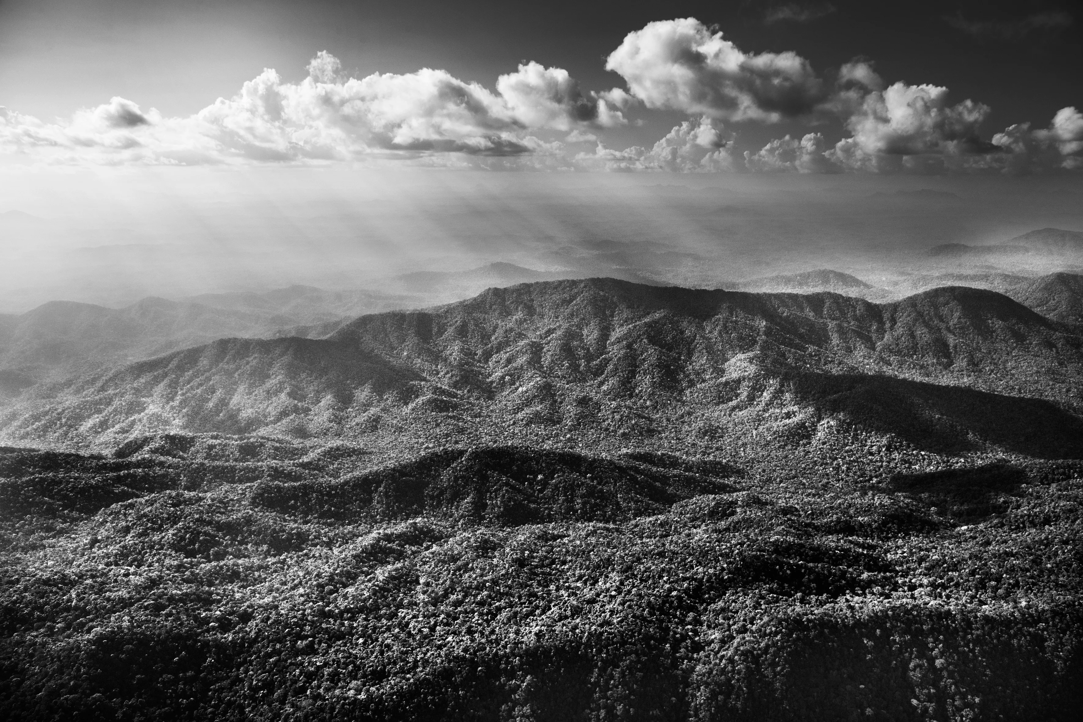 Imeri mountain range, State of Amazonas, Brazil, 2018

The mountain range that defines the life of the Amazon basin lies far to the west of Brazil. But if the Andes provides most of the water that flows through hundreds of tributaries into the Amazon River, Brazil too can boast mountains. To the southeast lie the Brazilian Highlands, which include the mineral rich state of Minas Gerais. Heading north towards the heart of the rainforest, the landscape remains undulating, with a hilltop known as Serra Pelada in the state of Pará drawing one of the country's biggest-ever gold rushes in the 1980s. Even closer to the Amazon River, occasional large rock formations appear like intruders into the quiet order of the lowlands.