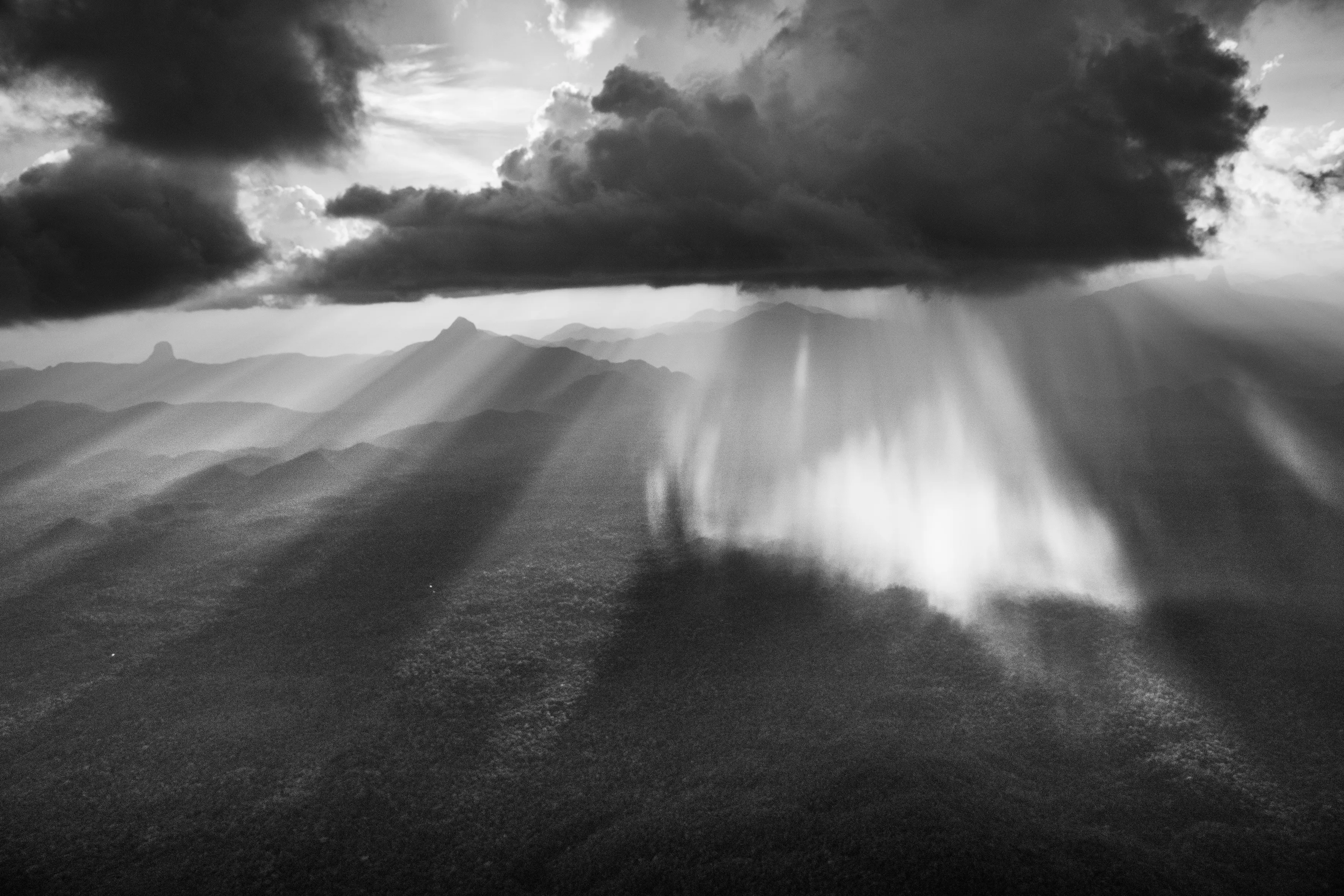 São Gabriel da Cachoeira Municipality, State of Amazonas, Brazil, 2018

Over the Amazon rainforest, rare is the day when you can see a clear sheet of blue sky or a solid blanket of gray cloud. Rather cloud formations offer an ever-changing spectacle. This begins in the morning when warm moist air rises from the jungle and makes contact with minuscule particles which permit the vapor to condense into water droplets and become little clouds resembling cotton balls known locally as aru. As the day advances, they rise and join forces and, temperature and wind speed permitting, gather strength to become a storm cloud known as a cumulonimbus. This is quite the most dangerous meteorological formation, reaching several thousand meters into the sky, spewing out pieces of ice and winds of up to 200 kilometers per hour (125 miles per hour) at the same time as sending lightning, strong winds, and fierce precipitation toward the jungle. Such is its force that even large aircraft will do everything to avoid it, helicopters immediately look for a jungle clearing in order to land and riverboats hurriedly take shelter from the blinding rain.