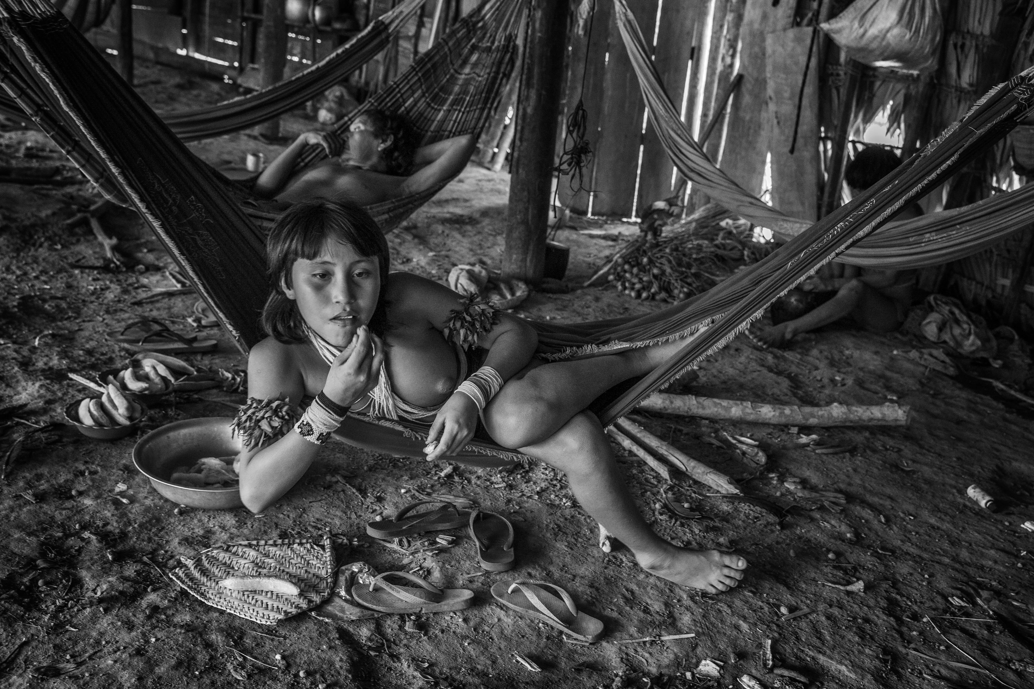 The communal maloca of Watoriki, Yanomami Indigenous Territory, State of Amazonas, Brazil, 2014.

The Yanomami are the largest low-contact indigenous ethnic group in the world. They have a population of around 40,000 people, with 28,000 in Brazil and the rest in Venezuela. They live in mountains ranges and valleys in the far north of Brazil, in the country's largest indigenous territory. The land extends from the north of the state of Roraima to the Rio Negro in the state of Amazonas. Shamanism is central to Yanomami culture. Their main leader is the shaman Davi Kopenawa, a pioneer in the campaign to establish the Yanomami Indigenous Territory, starting in the late 1970s. In 1993, Haximu, a Yanomami community, suffered a massacre by illegal miners. This led to the only conviction for the crime of genocide in the entire history of Brazilian justice. The Yanomami include at least one isolated group.