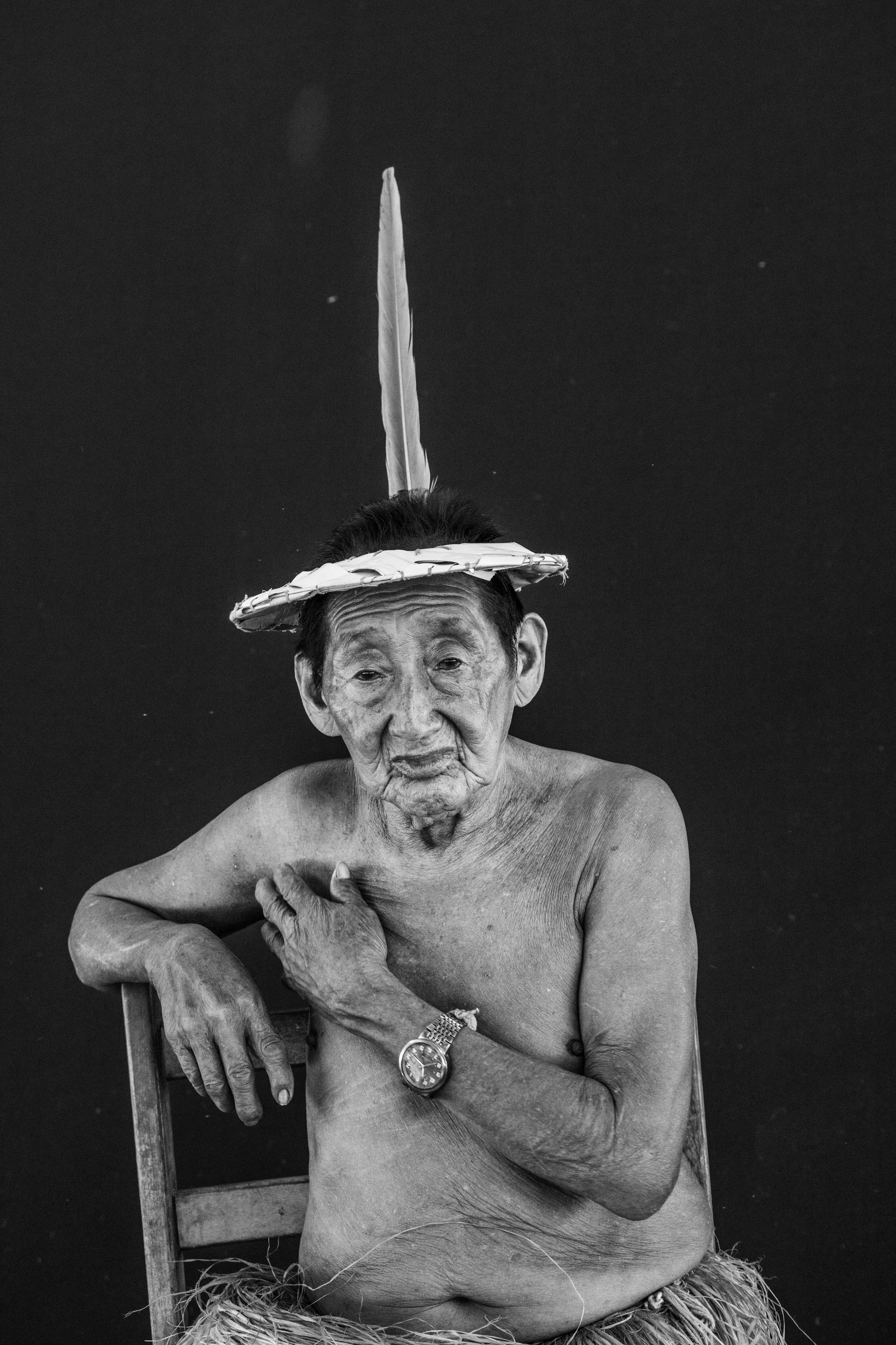 The village of Mutum, Rio Gregório Yawanawá Indigenous Territory, State of Acre, Brazil, 2016.

In the course of some 50 years, the Yawanawá have emerged from complete invisibility into a period of exuberant cultural activity, becoming a reference point for sustainable living and indigenous culture for travelers from all over the world. In 1970, there were just 120 of them, with rampant alcoholism and the resulting social and cultural breakdown, to the point where their language was about to disappear. They were pressured not to use their language in front of whites, mainly by the owners of the rubber plantations, who controlled the forests of Acre from the late 19th century. The plantation owners treated them as slaves and did not want the language to reveal the existence of native tribes who might claim ownership of the land. Another threat was posed by Evangelical missionaries who had enforced Christian worship and attacked traditional indigenous rites as "demonic." Biraci Brasil Yawanawá, better known as Bira, assumed leadership of the group in the early 1990s, expelled the missionaries, got rid of the bibles, reestablished teaching of the traditional language, and began encouraging study of the old myths and stories as a way to pass down the old people's knowledge and memories to the new generations. In three decades, the population has grown to about 1,200 people.