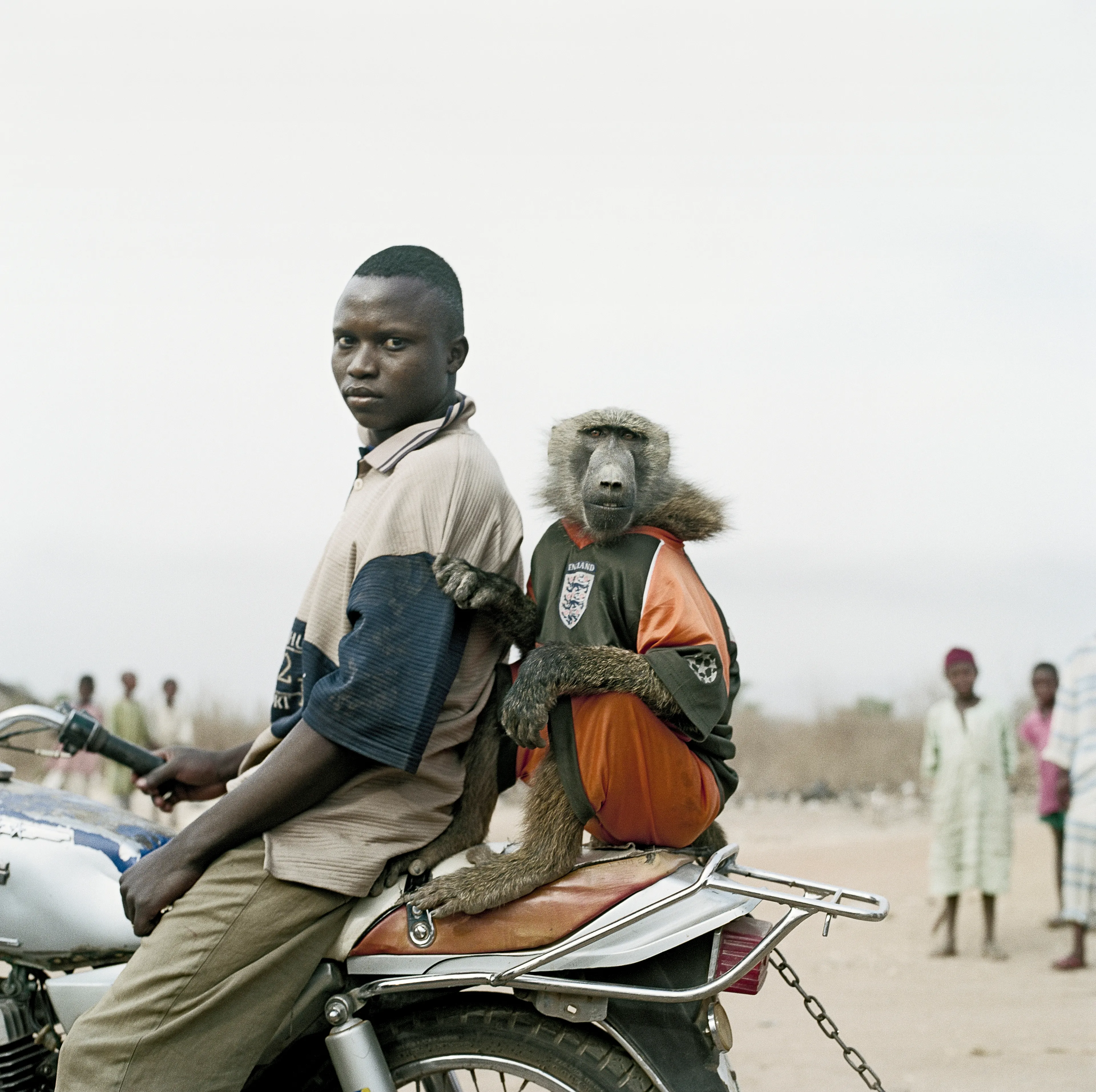 Pieter Hugo’s The Hyena and Other Men (2005-2007) is a portrait series produced in Nigeria about a community of ‘hyena men’ who together form a community around the ownership of exotic animals, predominantly hyenas, but pythons and monkeys as well. Dubbed the “Gadawan Kura” (which roughly translates from Hausa to “hyena handlers”), these men make a living by capturing, training, and performing with these animals.

Edition: 1 of 1