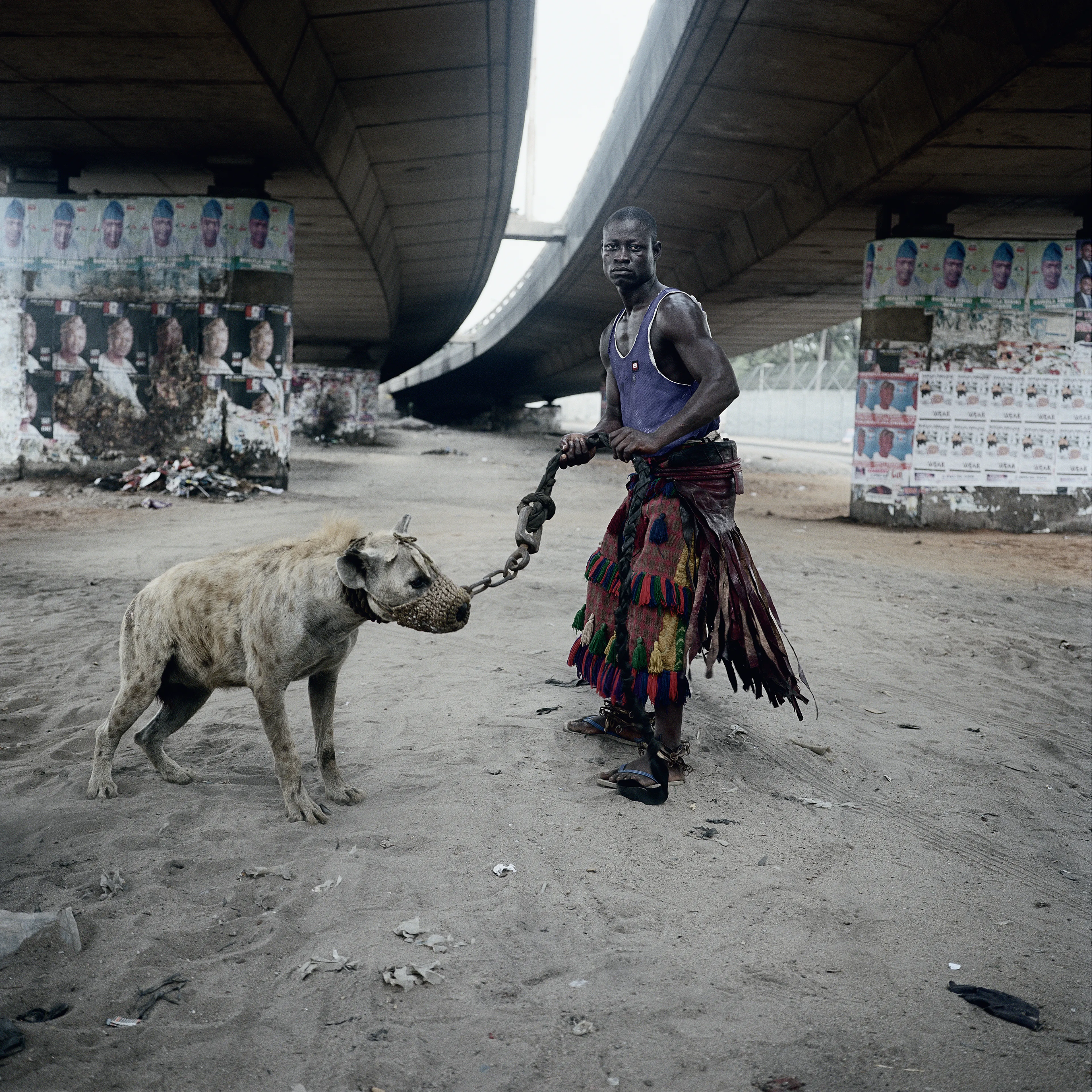 Pieter Hugo’s The Hyena and Other Men (2005-2007) is a portrait series produced in Nigeria about a community of ‘hyena men’ who together form a community around the ownership of exotic animals, predominantly hyenas, but pythons and monkeys as well. Dubbed the “Gadawan Kura” (which roughly translates from Hausa to “hyena handlers”), these men make a living by capturing, training, and performing with these animals.

Edition: 1 of 1