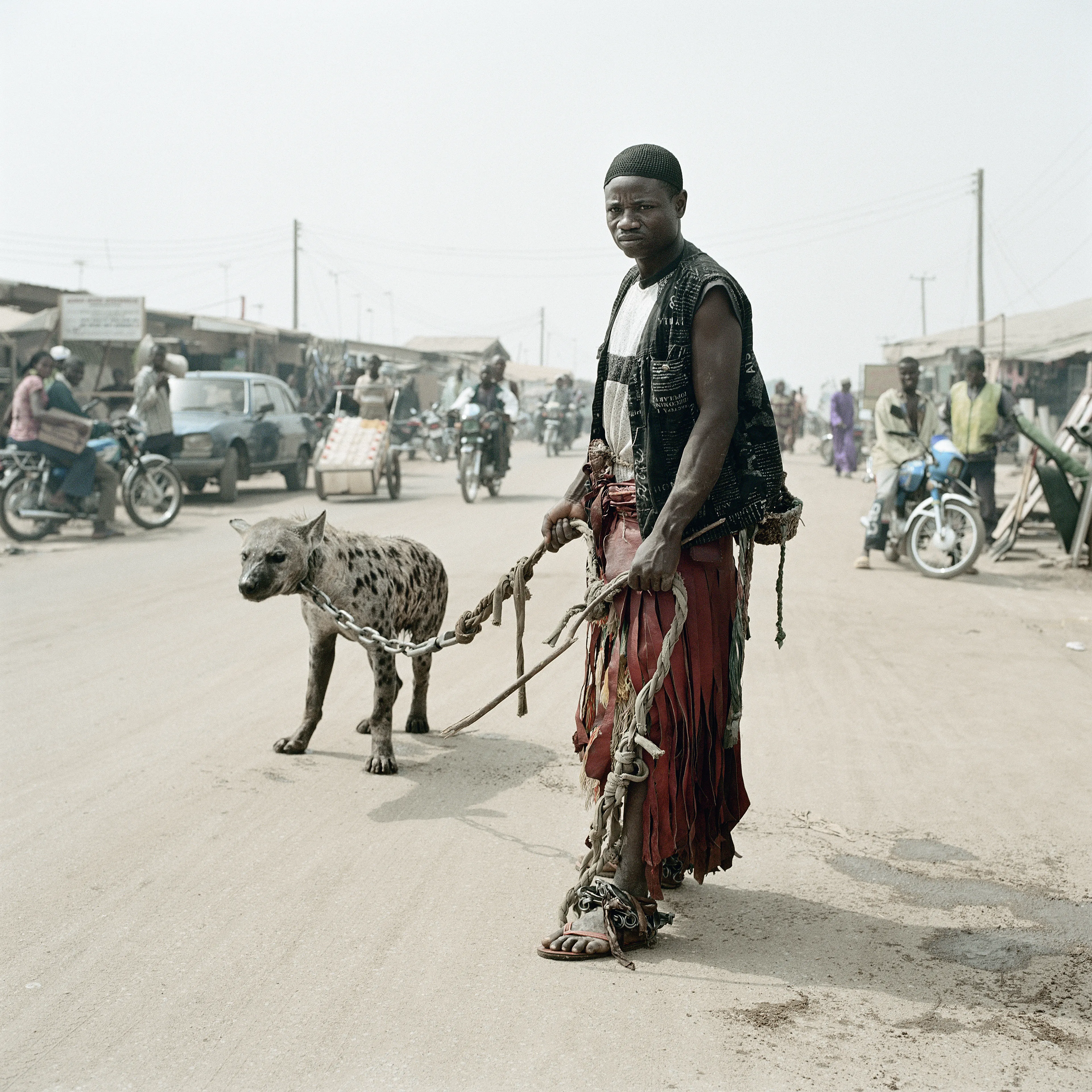 Pieter Hugo’s The Hyena and Other Men (2005-2007) is a portrait series produced in Nigeria about a community of ‘hyena men’ who together form a community around the ownership of exotic animals, predominantly hyenas, but pythons and monkeys as well. Dubbed the “Gadawan Kura” (which roughly translates from Hausa to “hyena handlers”), these men make a living by capturing, training, and performing with these animals.

Edition: 1 of 1