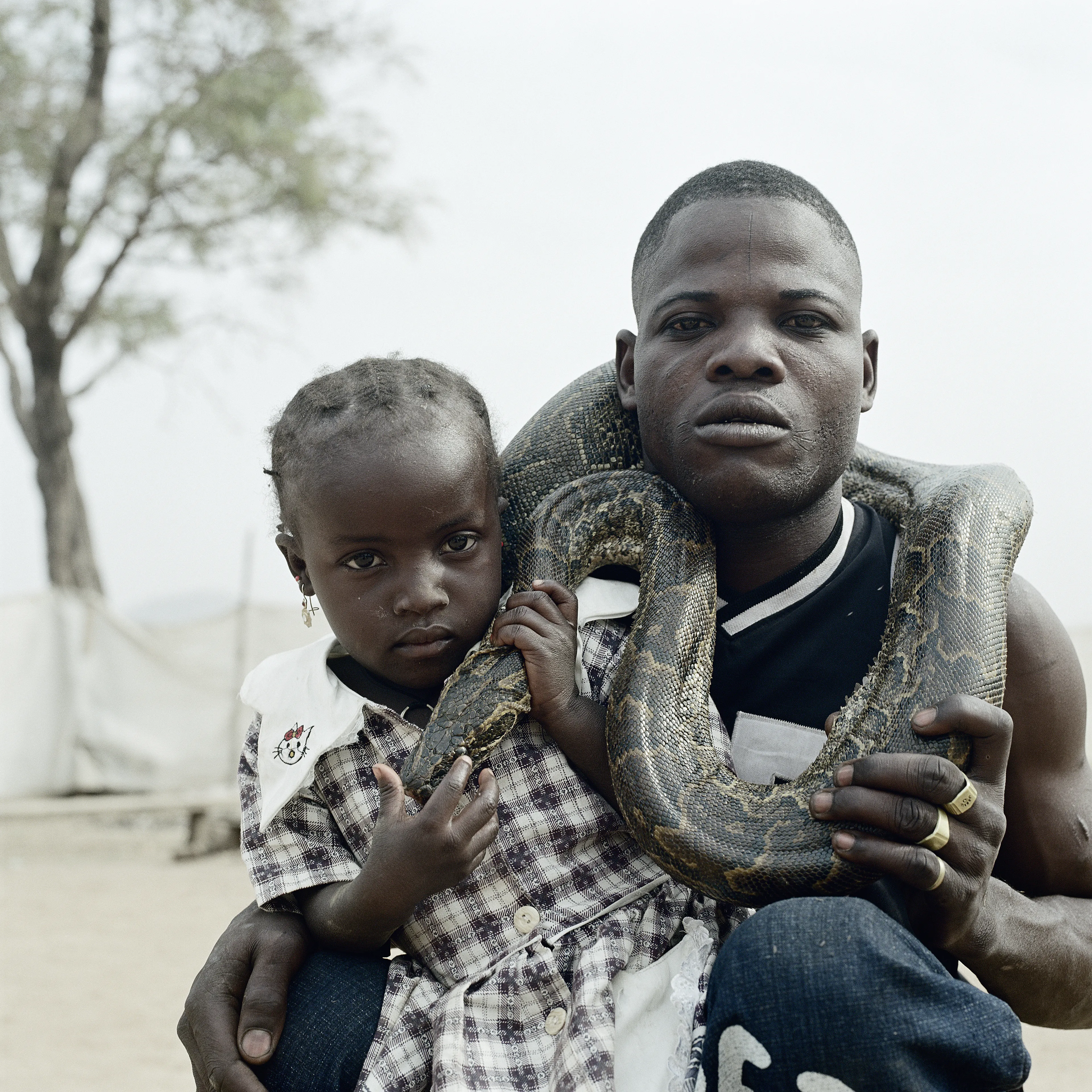 Pieter Hugo’s The Hyena and Other Men (2005-2007) is a portrait series produced in Nigeria about a community of ‘hyena men’ who together form a community around the ownership of exotic animals, predominantly hyenas, but pythons and monkeys as well. Dubbed the “Gadawan Kura” (which roughly translates from Hausa to “hyena handlers”), these men make a living by capturing, training, and performing with these animals.

Edition: 1 of 1