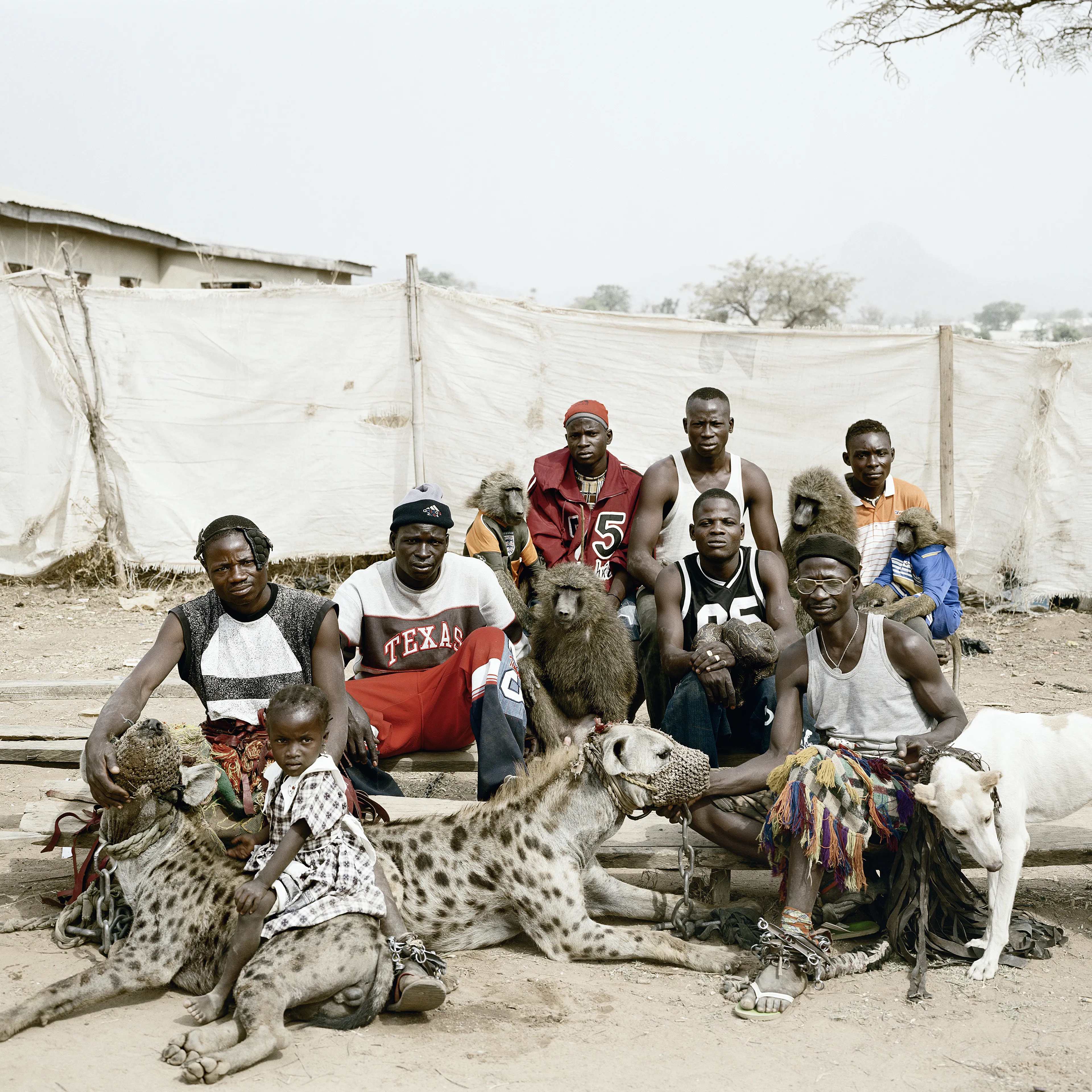 Pieter Hugo’s The Hyena and Other Men (2005-2007) is a portrait series produced in Nigeria about a community of ‘hyena men’ who together form a community around the ownership of exotic animals, predominantly hyenas, but pythons and monkeys as well. Dubbed the “Gadawan Kura” (which roughly translates from Hausa to “hyena handlers”), these men make a living by capturing, training, and performing with these animals.

Edition: 1 of 1