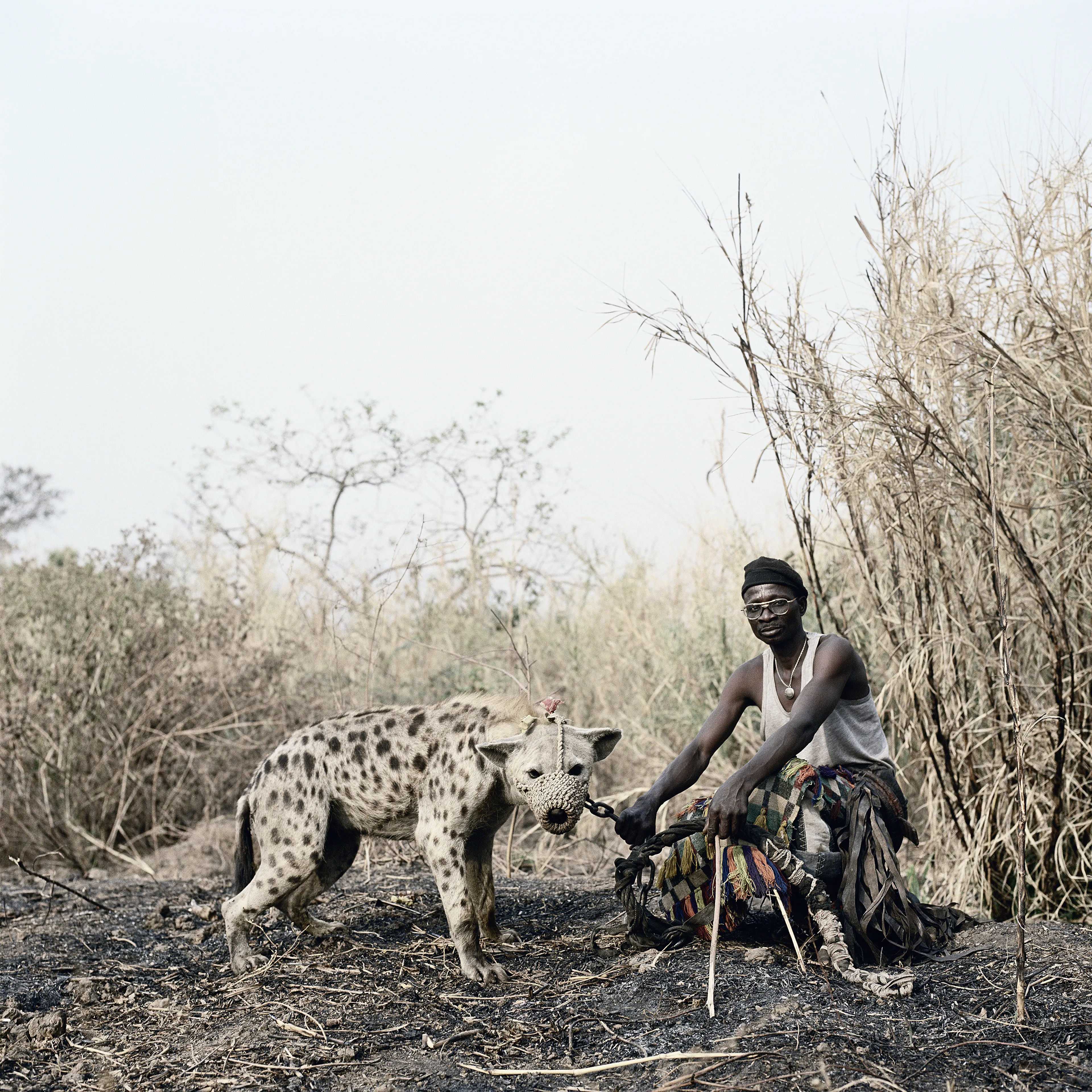 Pieter Hugo’s The Hyena and Other Men (2005-2007) is a portrait series produced in Nigeria about a community of ‘hyena men’ who together form a community around the ownership of exotic animals, predominantly hyenas, but pythons and monkeys as well. Dubbed the “Gadawan Kura” (which roughly translates from Hausa to “hyena handlers”), these men make a living by capturing, training, and performing with these animals.

Edition: 1 of 1