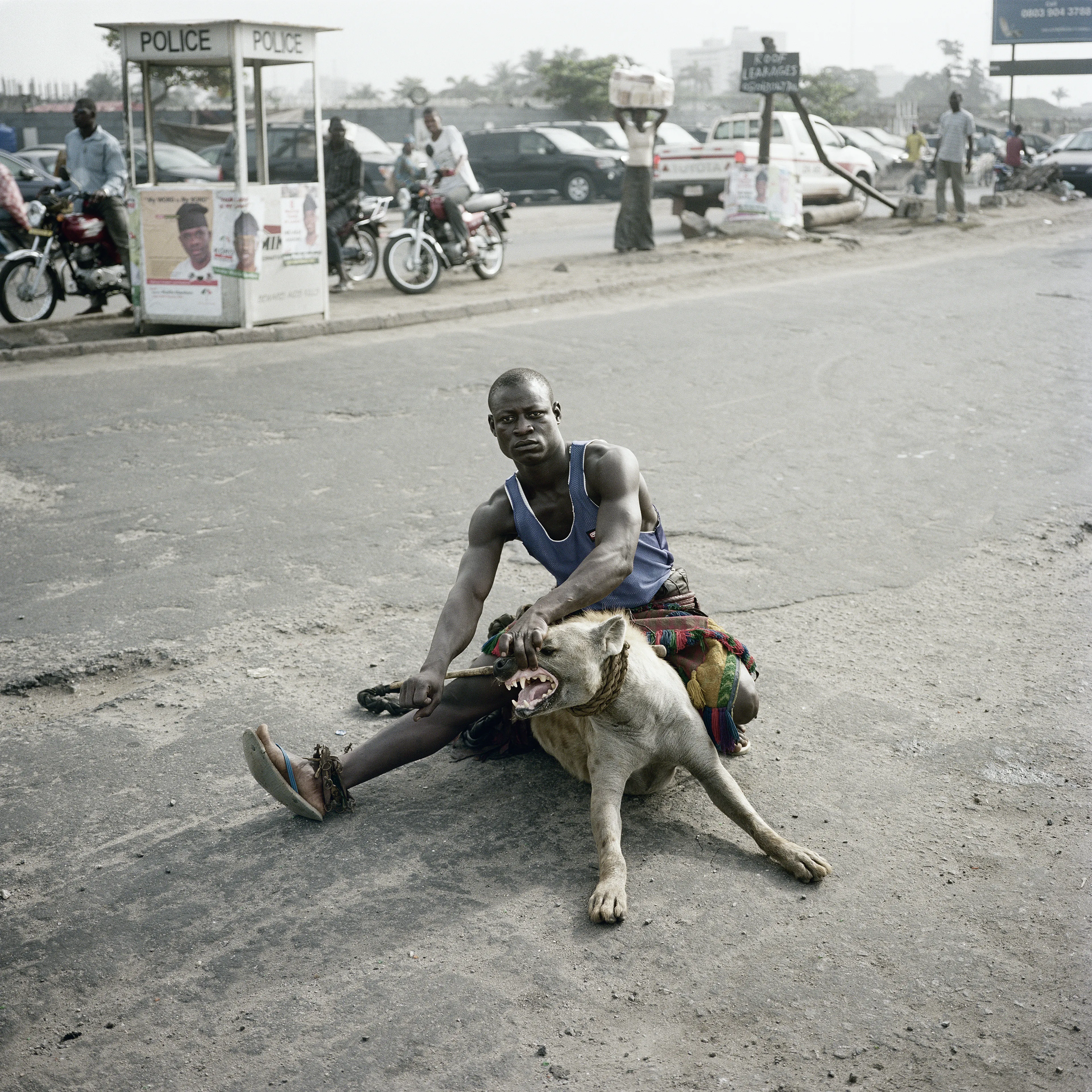 Pieter Hugo’s The Hyena and Other Men (2005-2007) is a portrait series produced in Nigeria about a community of ‘hyena men’ who together form a community around the ownership of exotic animals, predominantly hyenas, but pythons and monkeys as well. Dubbed the “Gadawan Kura” (which roughly translates from Hausa to “hyena handlers”), these men make a living by capturing, training, and performing with these animals.

Edition: 1 of 1