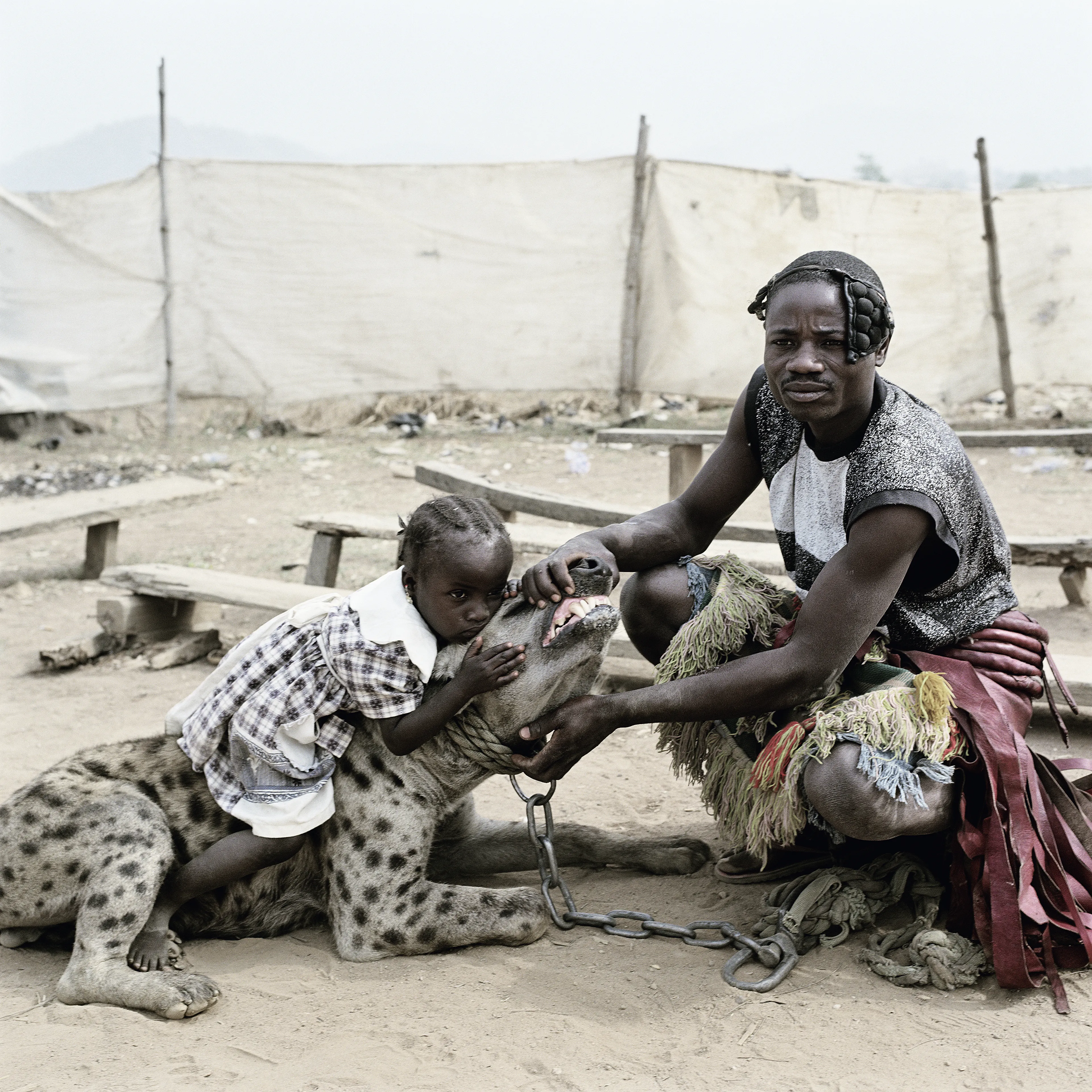 Pieter Hugo’s The Hyena and Other Men (2005-2007) is a portrait series produced in Nigeria about a community of ‘hyena men’ who together form a community around the ownership of exotic animals, predominantly hyenas, but pythons and monkeys as well. Dubbed the “Gadawan Kura” (which roughly translates from Hausa to “hyena handlers”), these men make a living by capturing, training, and performing with these animals.

Edition: 1 of 1