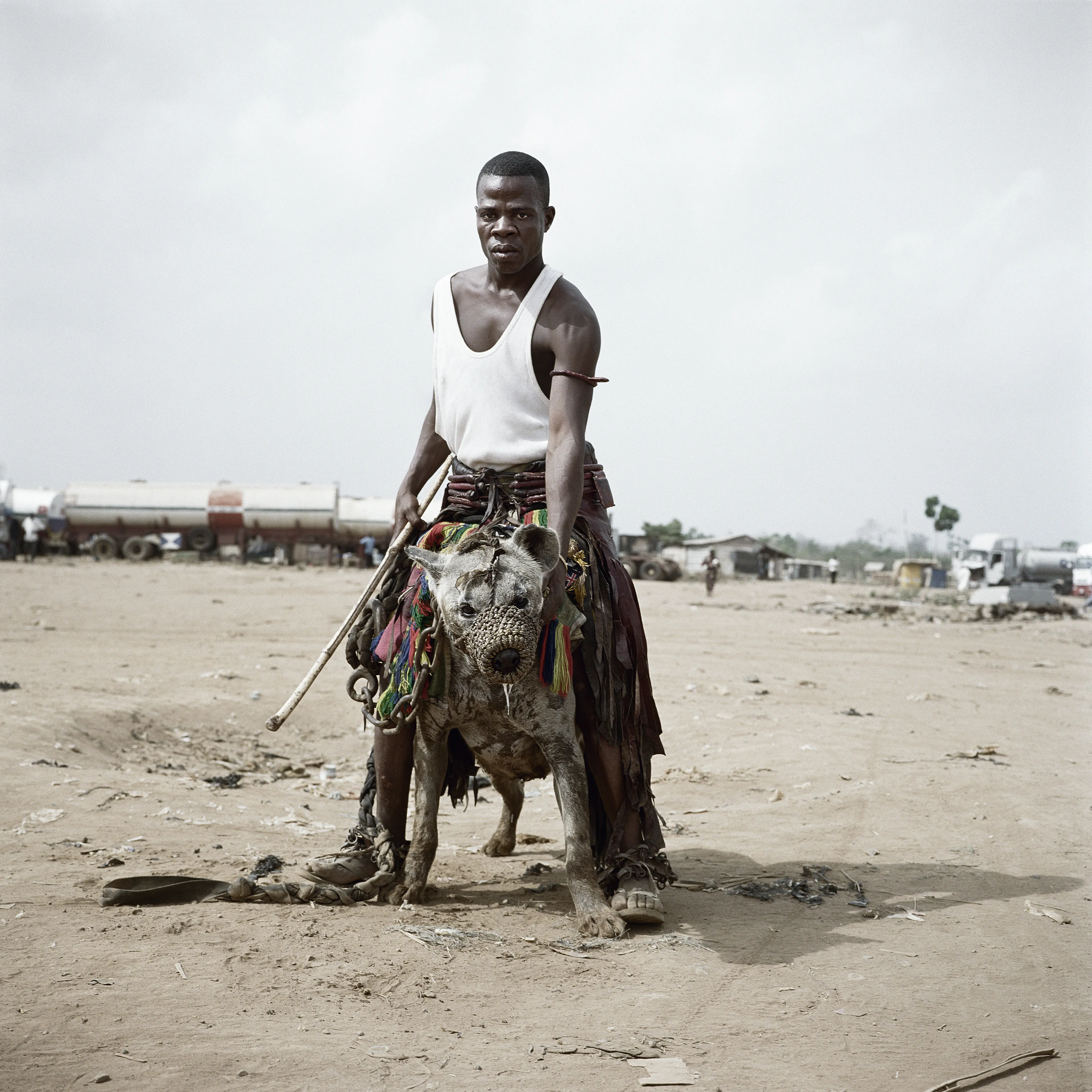 Pieter Hugo’s The Hyena and Other Men (2005-2007) is a portrait series produced in Nigeria about a community of ‘hyena men’ who together form a community around the ownership of exotic animals, predominantly hyenas, but pythons and monkeys as well. Dubbed the “Gadawan Kura” (which roughly translates from Hausa to “hyena handlers”), these men make a living by capturing, training, and performing with these animals.

Edition: 1 of 1