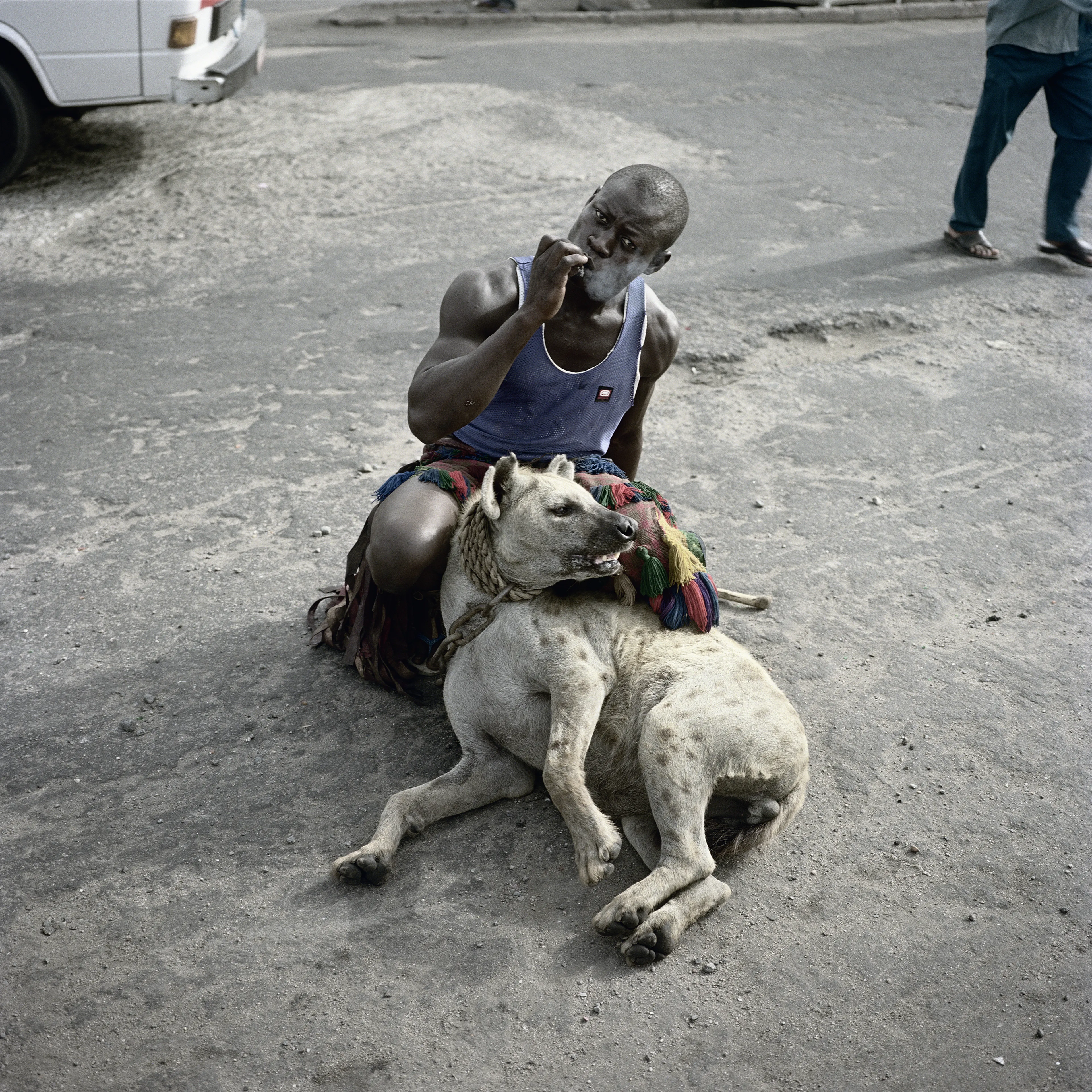 Pieter Hugo’s The Hyena and Other Men (2005-2007) is a portrait series produced in Nigeria about a community of ‘hyena men’ who together form a community around the ownership of exotic animals, predominantly hyenas, but pythons and monkeys as well. Dubbed the “Gadawan Kura” (which roughly translates from Hausa to “hyena handlers”), these men make a living by capturing, training, and performing with these animals.

Edition: 1 of 1