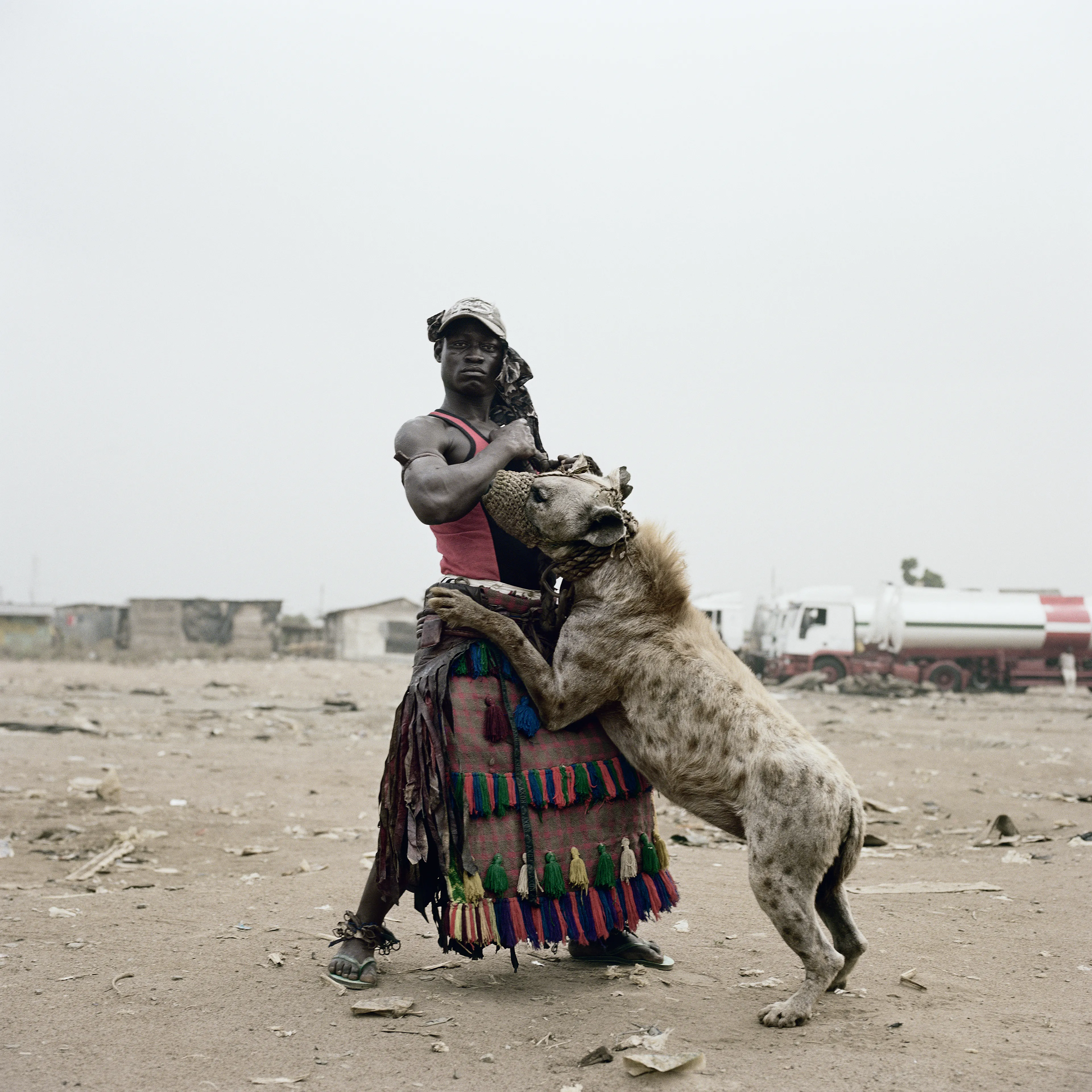 Pieter Hugo’s The Hyena and Other Men (2005-2007) is a portrait series produced in Nigeria about a community of ‘hyena men’ who together form a community around the ownership of exotic animals, predominantly hyenas, but pythons and monkeys as well. Dubbed the “Gadawan Kura” (which roughly translates from Hausa to “hyena handlers”), these men make a living by capturing, training, and performing with these animals.

Edition: 1 of 1