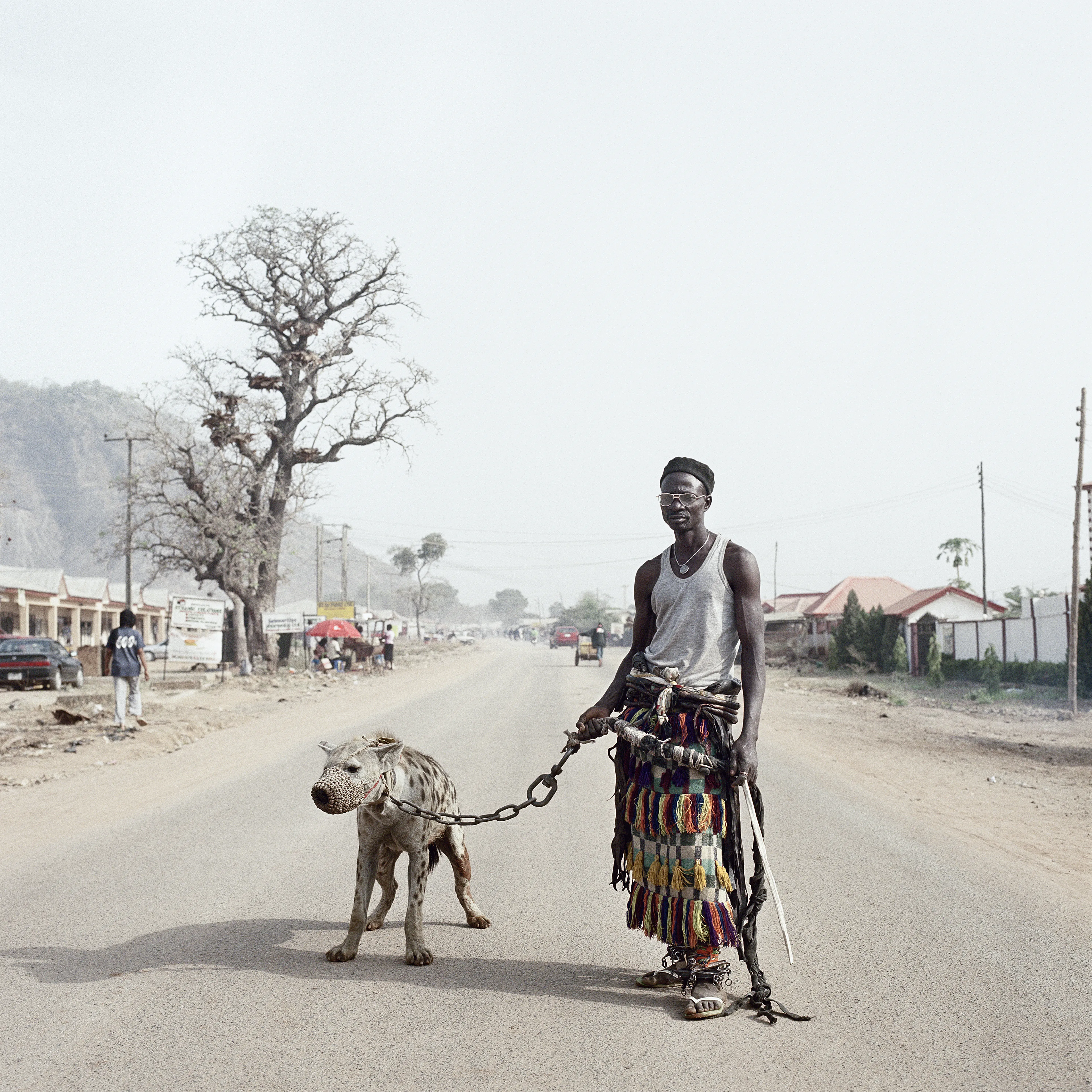 Pieter Hugo’s The Hyena and Other Men (2005-2007) is a portrait series produced in Nigeria about a community of ‘hyena men’ who together form a community around the ownership of exotic animals, predominantly hyenas, but pythons and monkeys as well. Dubbed the “Gadawan Kura” (which roughly translates from Hausa to “hyena handlers”), these men make a living by capturing, training, and performing with these animals.

Edition: 1 of 1