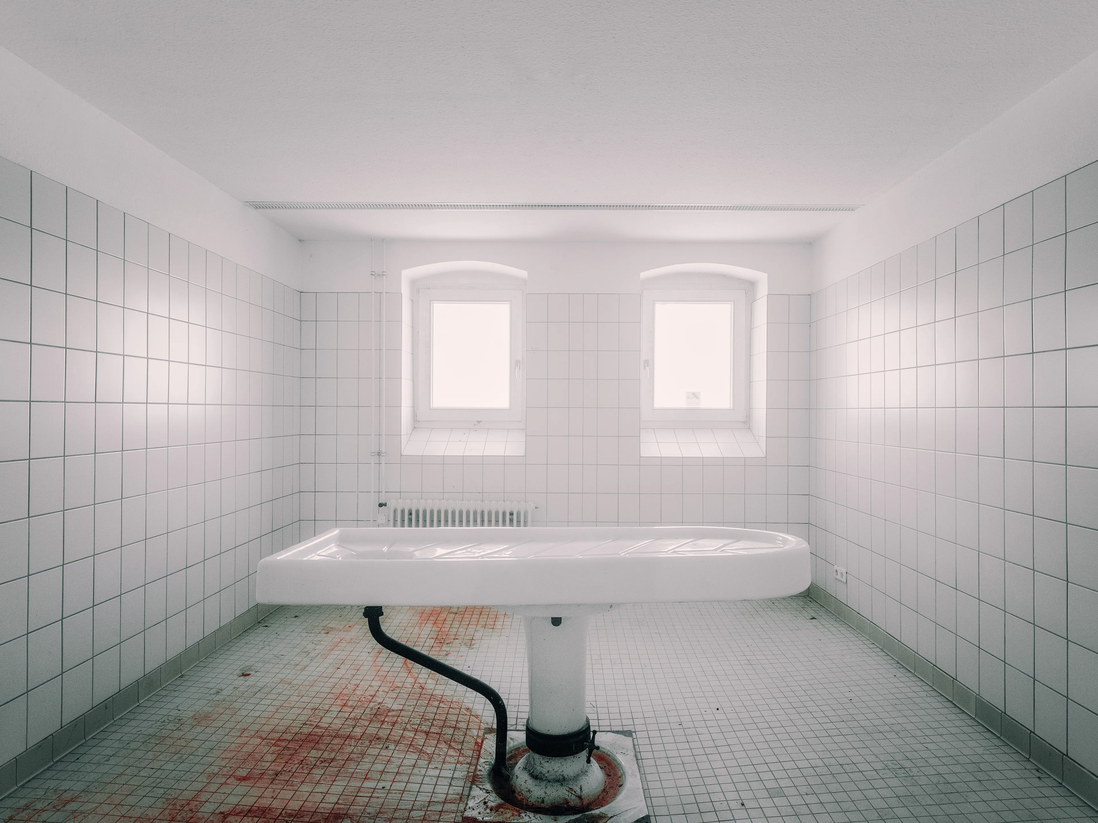 This is the Morgue in a former children's sanatorium in Germany. 

This picture was a really difficult one for me, as someone who lost her daughter early.  
But as a photographer I am an observer, an artist, a documenter and also the uncomfortable sides of our world need a mouthpiece. 

At the same time, Morgues also have a certain aesthetic when you focus on the visual. So clean, so accurate and minimalist.
