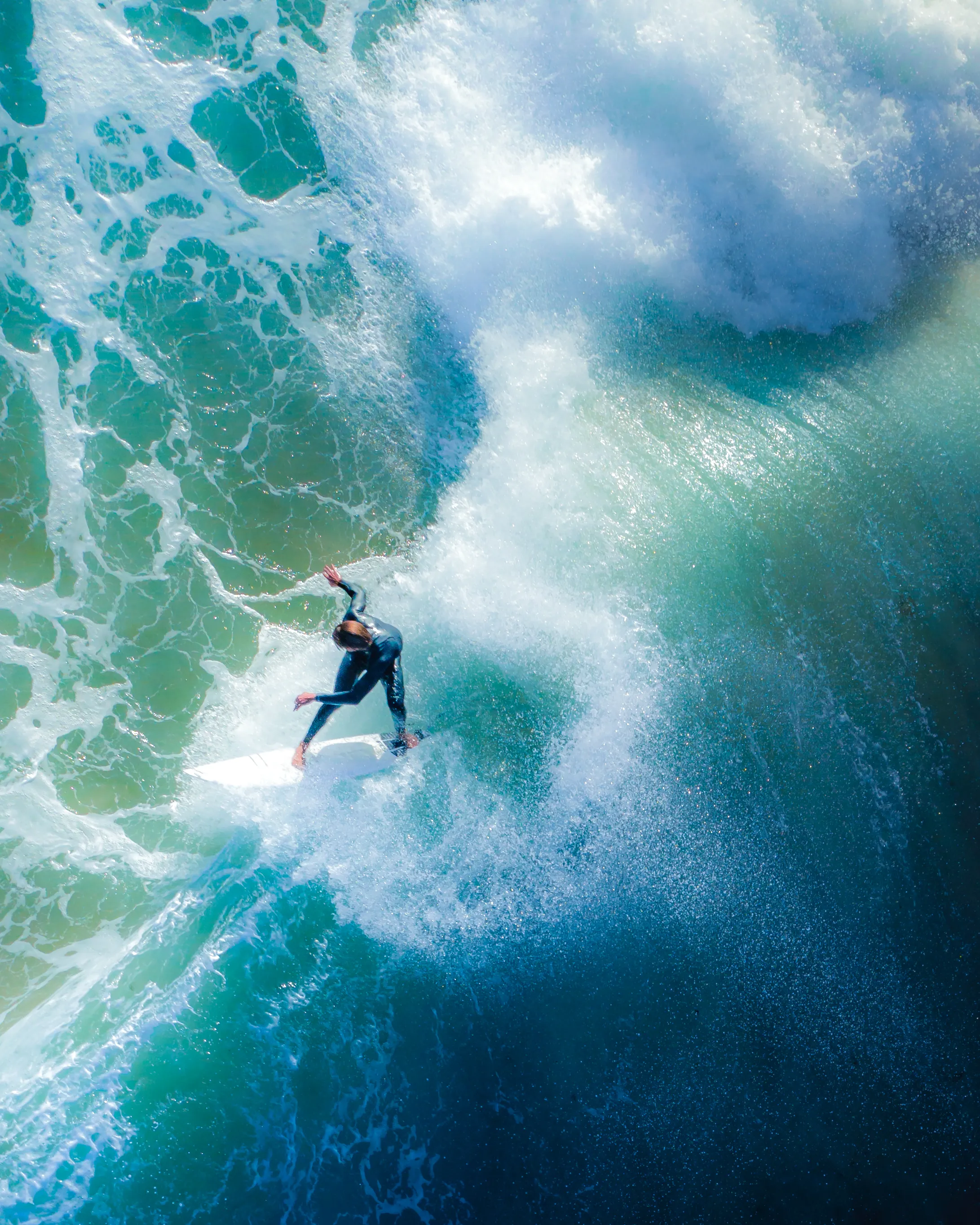Timing. Timing is everything when it comes to shooting surfers from the sky using a drone. Nailing the shot is not an easy thing to do with waves moving in one direction and the surfer another. Often waves will break in different places as well, so setting up in the right spot to get everything framed perfectly takes practice and intuition. 

Shutter speed is a large factor in getting everything sharp and in focus, as well as many other fine tuned factors and tweaks that come from years of dedication perfecting this style of photography. 

This is one of my favourite images I have captured of a surfer with style carving up the lip of the wave, the ocean spray off the back and the rich vibrant tones of the ocean. 

It has taken years of experimentation to capture a frame like this and I still get excited when I catch one, as they are few and far between.

Artist: New Light Visuals 
 
Title: Snap Back  

Edition: 1/1