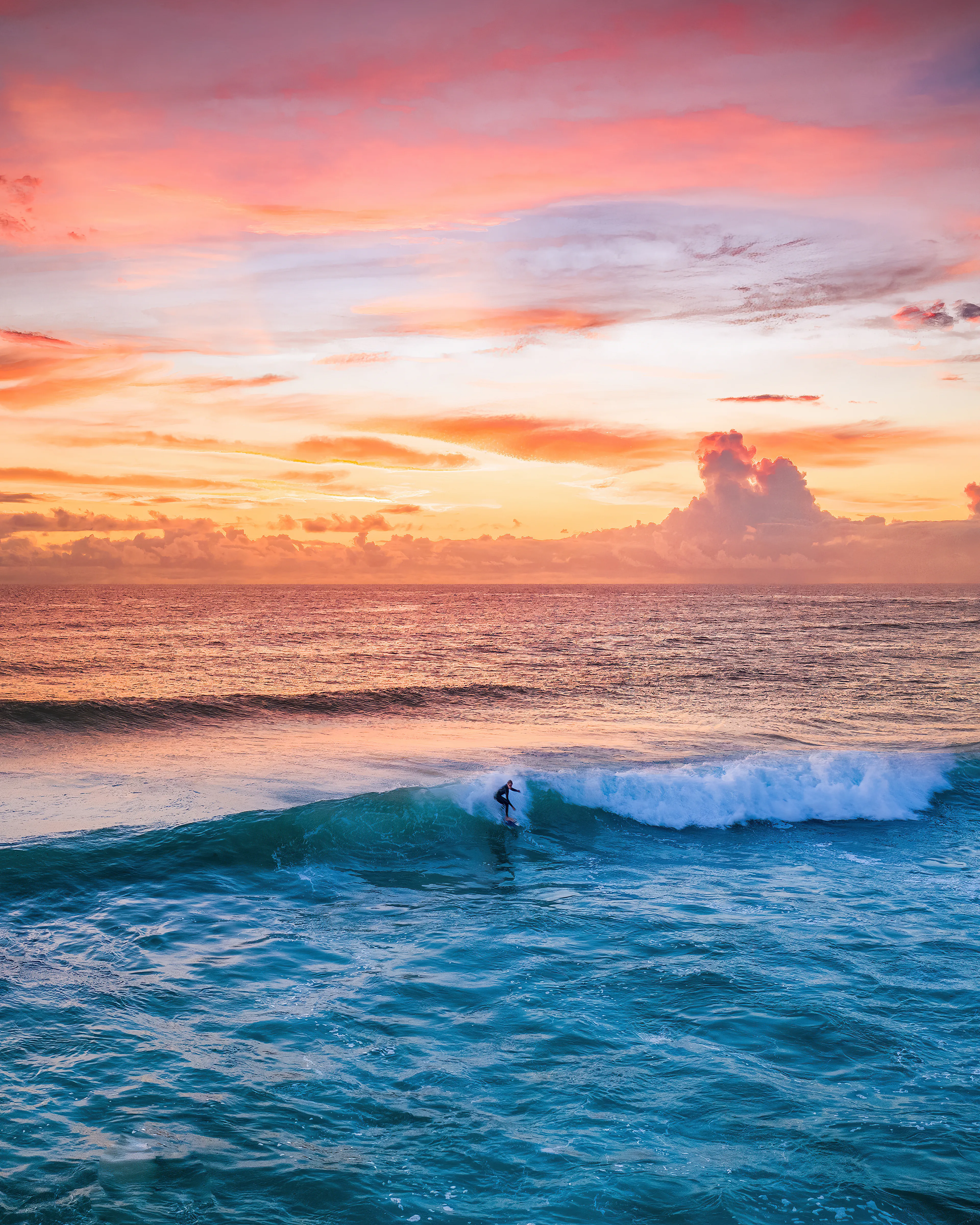 The first moments of the day. Most people are tucked up in bed while these troopers are making their way to beach side carparks in the dark, street lights still on, stretching wetsuits over head and getting ready to meet the waves.  
Having surfed all my life I am no stranger to this ritual, only nowadays I am torn between the board and the camera, having to choose between catching the first waves or capturing them. 
When the sky lights up like this and I am behind the lens I know I made the right call and each time it does, the shutter addiction overpowers the wave addiction a little more. I will never stop surfing, it is my saviour and my life source, I just might be later into the water than my usual routine as the days go on.

Artist: New Light Visuals 
https://twitter.com/newlightvisuals

Title: Fire Starter

Edition: 1/1