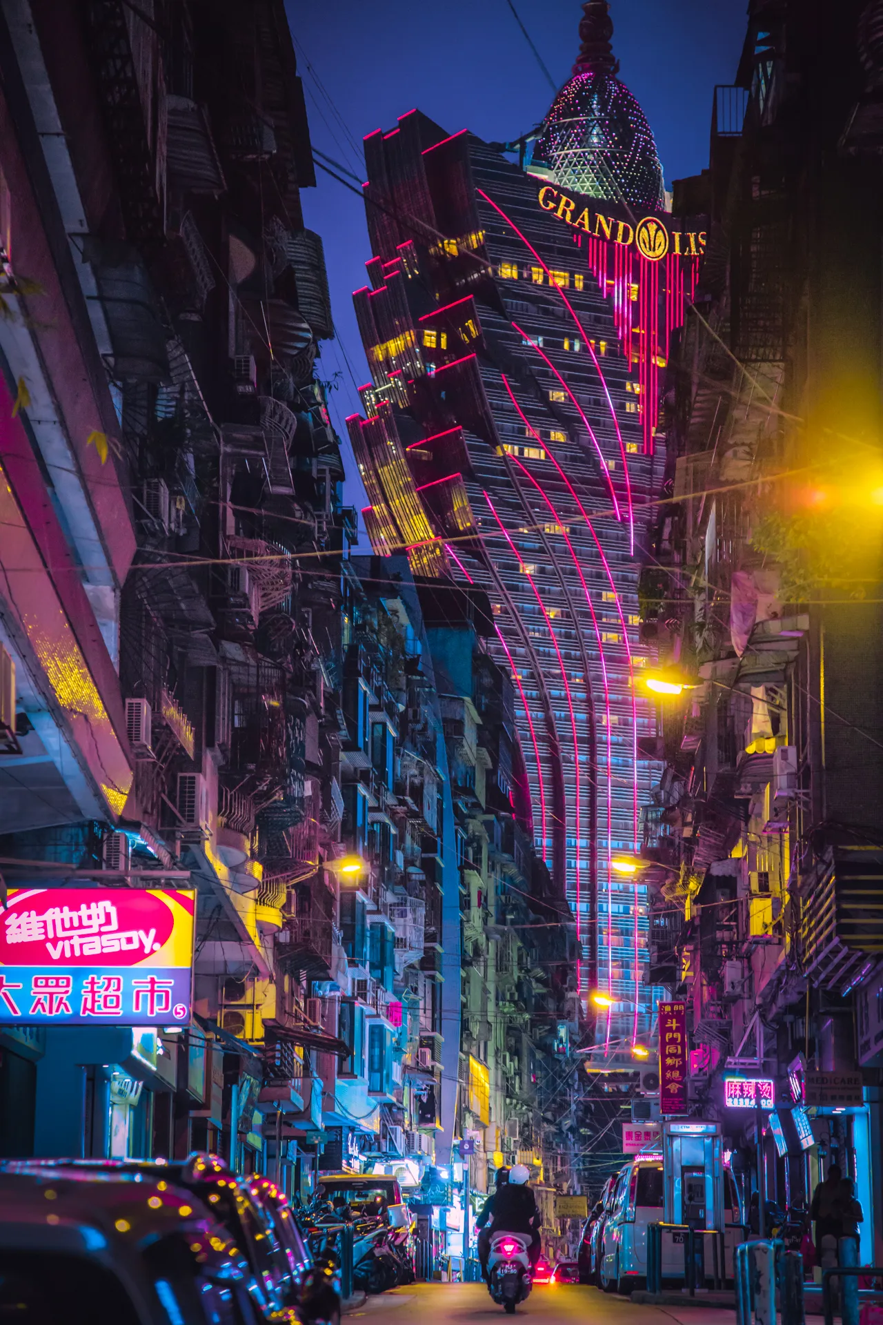 I believe 'The Grand Lisboa' is one of my top three photographs.  Initially, I had a variety of ideas that I wanted to do for animating this piece, but in the end,  I could not justify changing anything in this photograph.  

This image was shot in Macau, China during my one-night trip to the city. From Hong Kong, I took the ferry over to Macau for the evening, spending the entire night walking and taking photographs. I still recall the moment I came across the sight of The Grand Lisboa; it is a casino located in the middle of the city and looks like something from the future. I would love to continue exploring the world, looking for sights like these to share with others.  

---

**To enter this drawing, you must own at least 1 NFT on Nifty Gateway.**